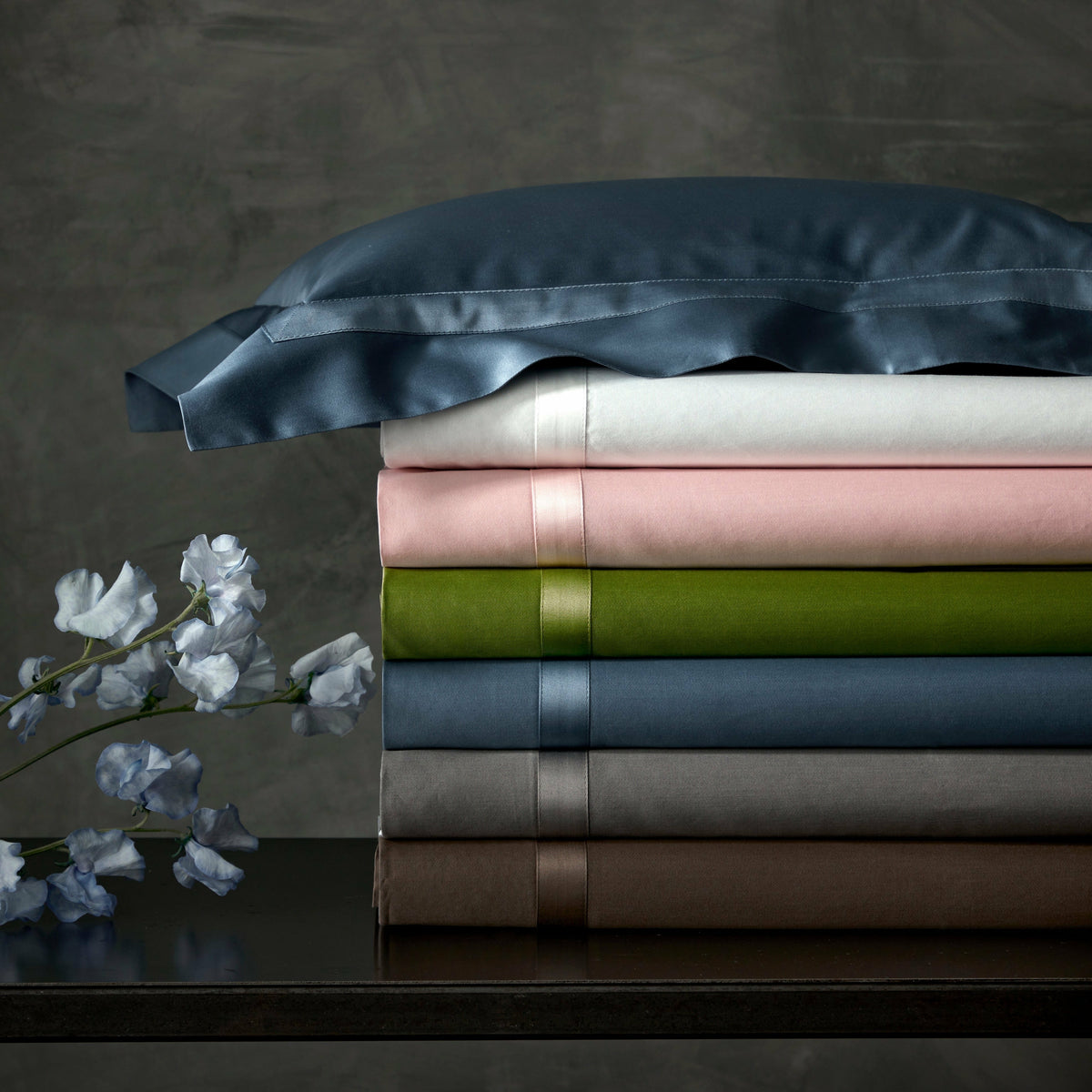 Stack of Matouk Nocturne Bedding Collection in Different Colors