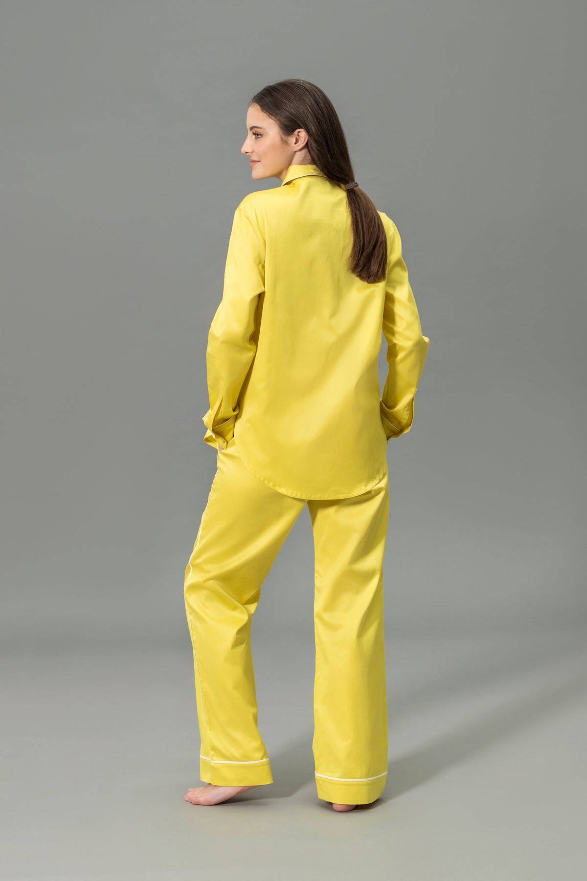Back View of Model Wearing Matouk Nocturne Pajama Set in Color Lemon and Bone