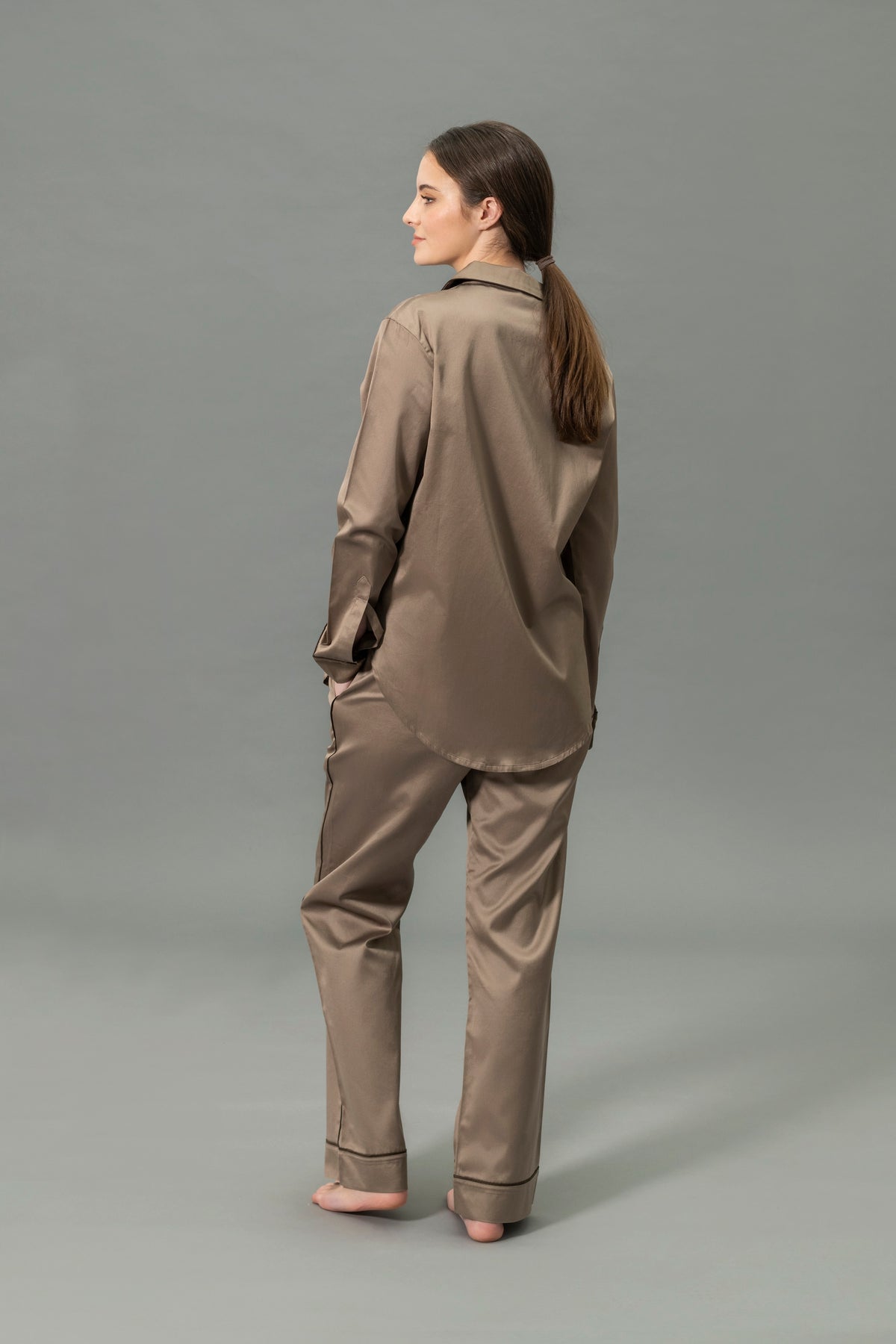 Back View of Model Wearing Matouk Nocturne Pajama Set in Color Mocha and Sable