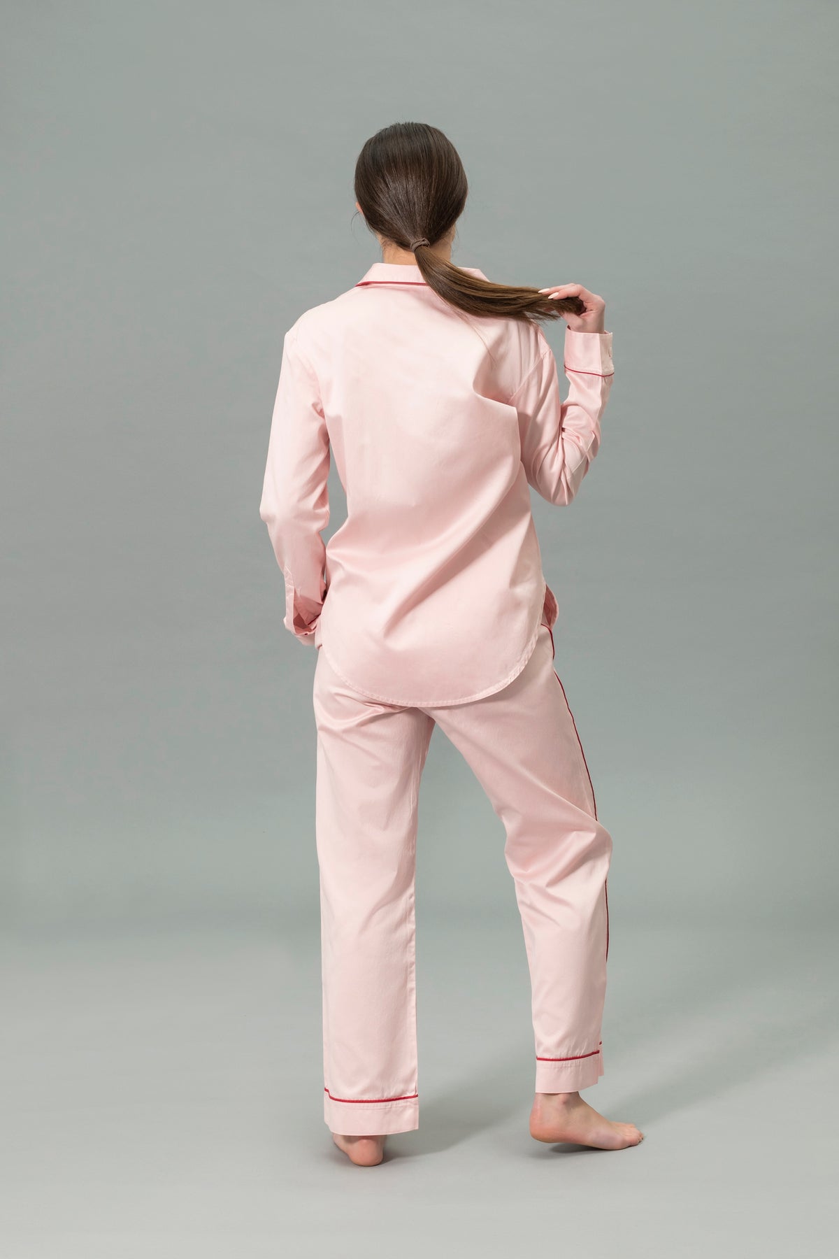 Back View of Model Wearing Matouk Nocturne Pajama Set in Color Pink and Scarlet