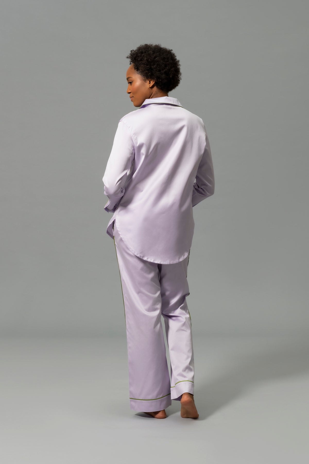 Back View of Model Wearing Matouk Nocturne Pajama Set in Color Violet and Grass
