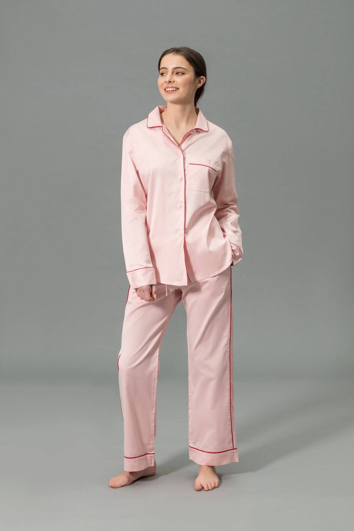 Front View of Model Wearing Matouk Nocturne Pajama Set in Color Pink and Scarlet
