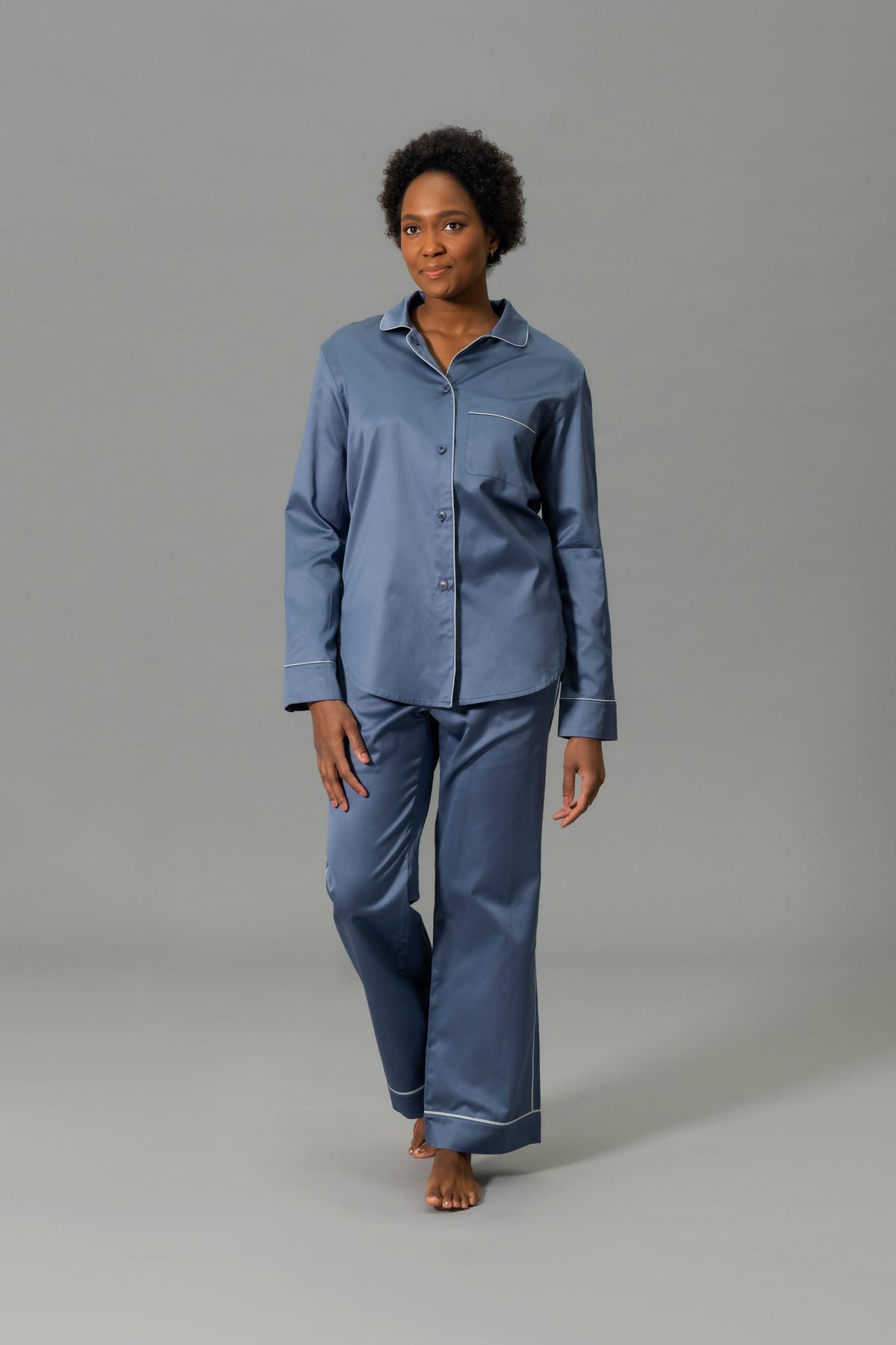 Front View of Model Wearing Matouk Nocturne Pajama Set in Color Steel Blue and Dove
