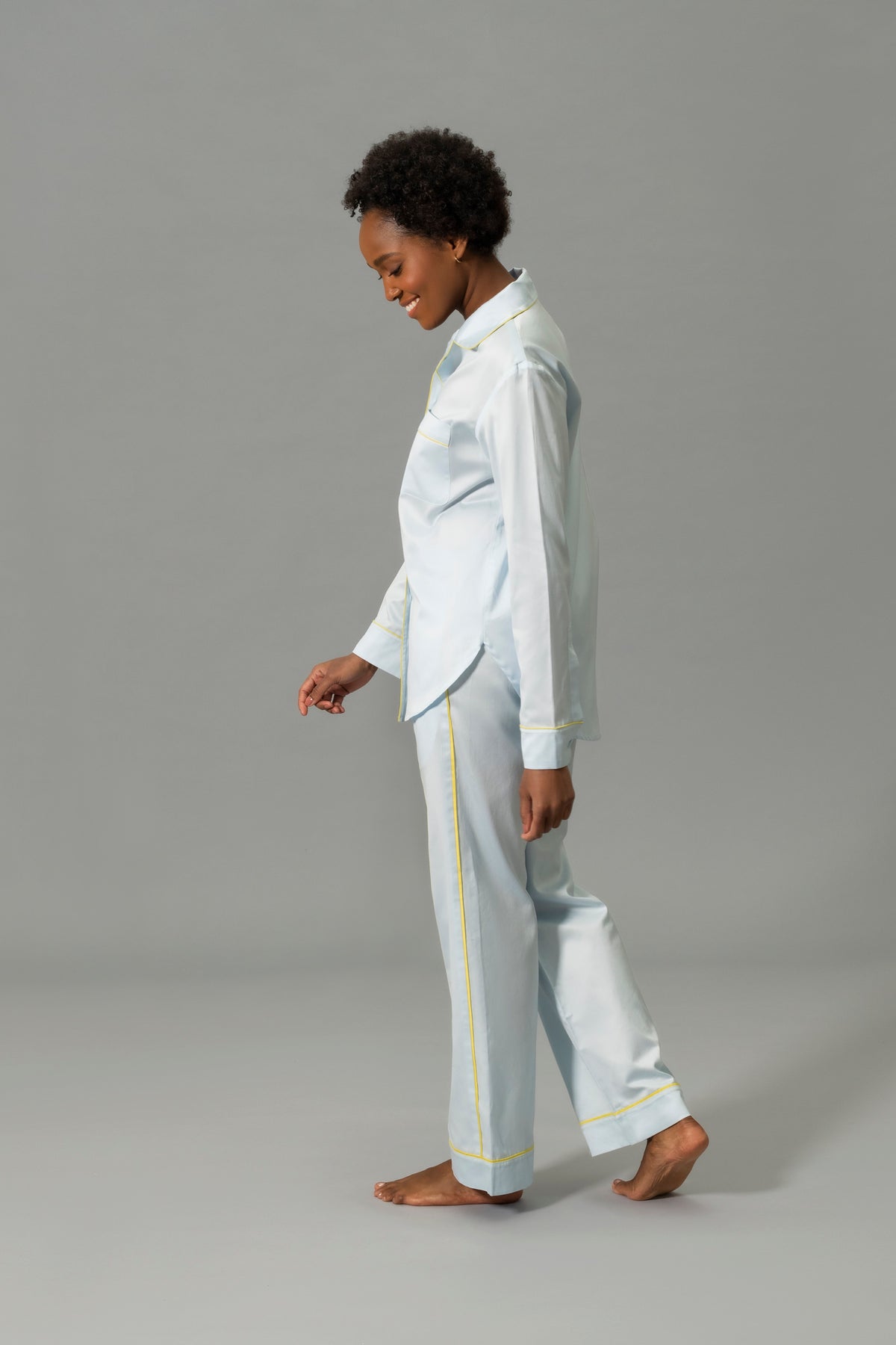 Side View of Model Wearing Matouk Nocturne Pajama Set in Color Blue and Lemon