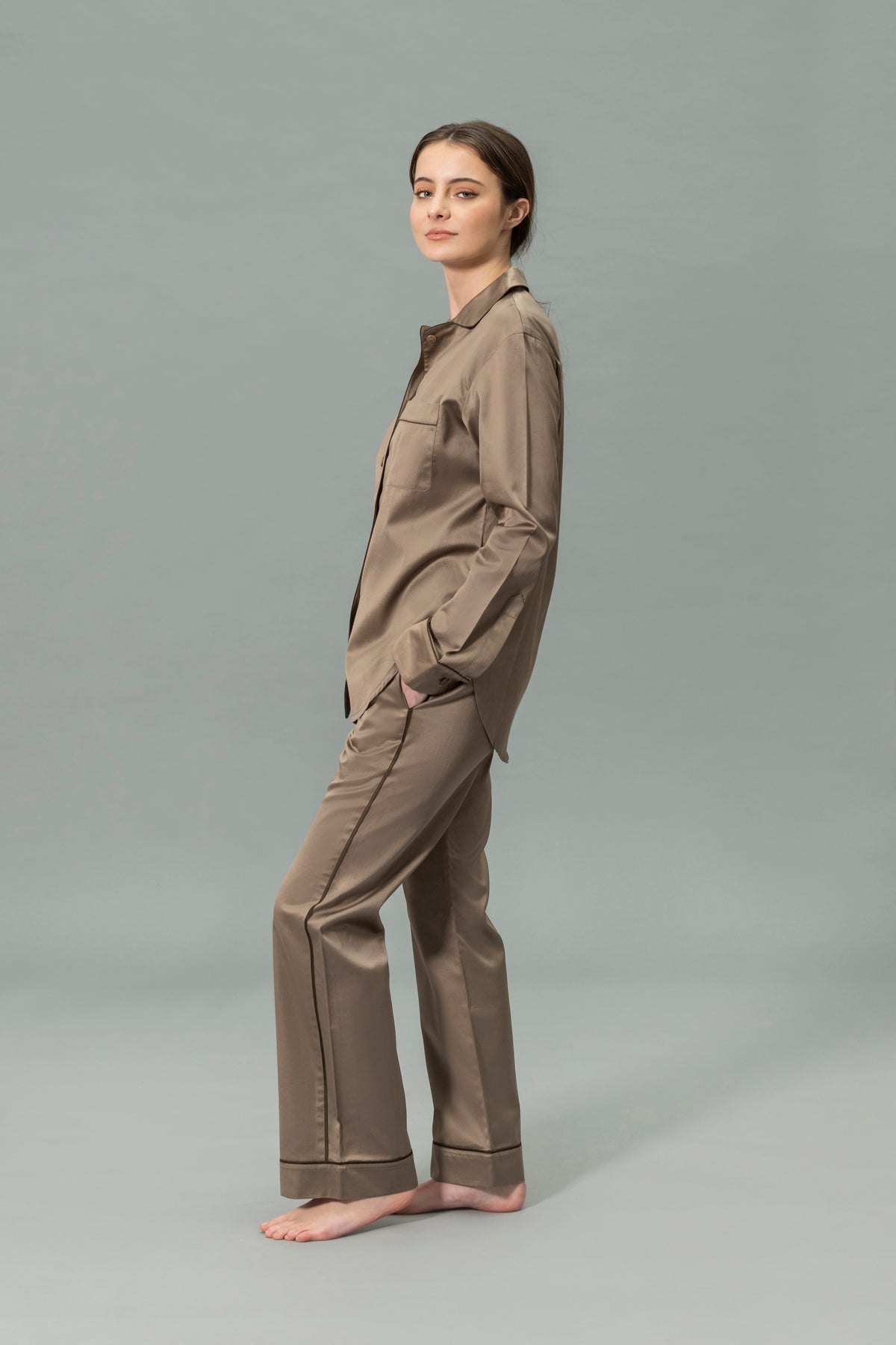 Side View of Model Wearing Matouk Nocturne Pajama Set in Color Mocha and Sable