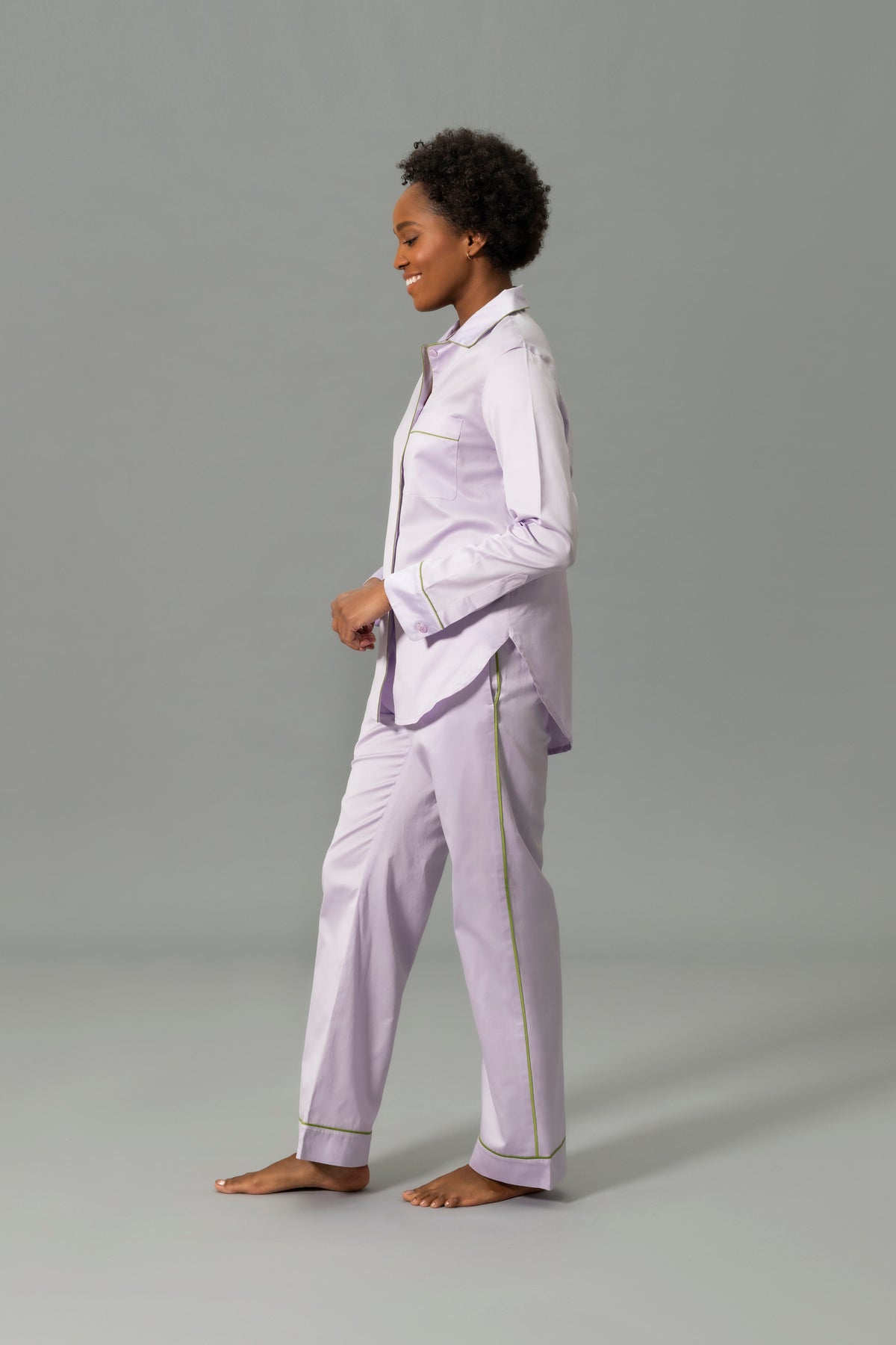 Side View of Model Wearing Matouk Nocturne Pajama Set in Color Violet and Grass