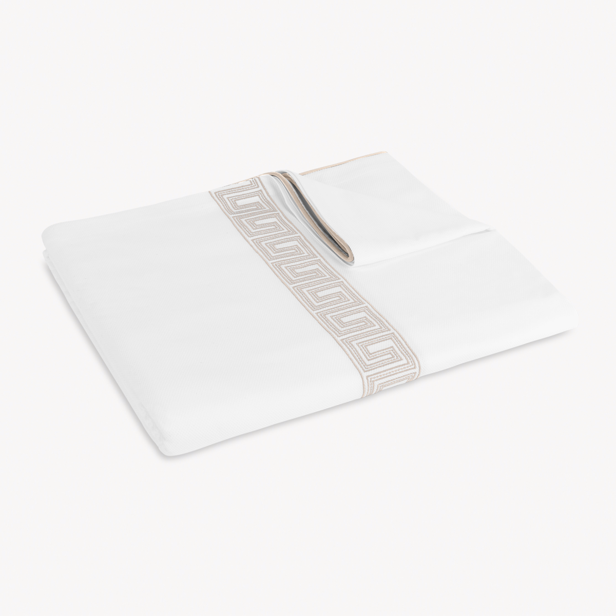 Folded Coverlet of Matouk Ophelia Pique Bedding in Dune