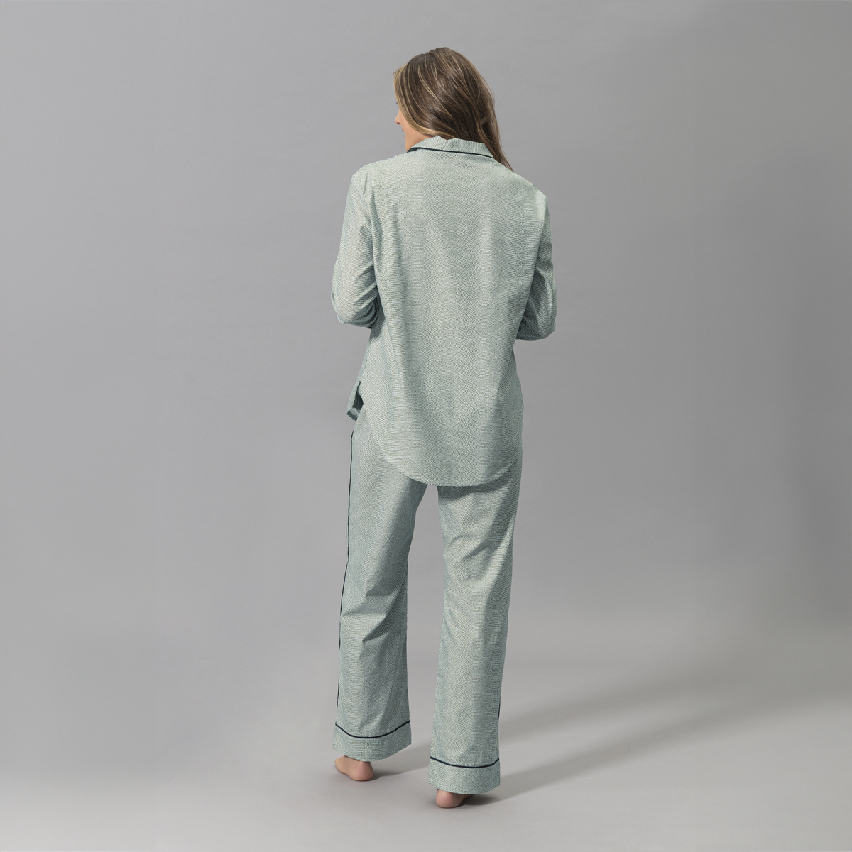 Behind Angle of a Woman Wearing a Matouk Jasper Pajama Set in Green and Navy Color