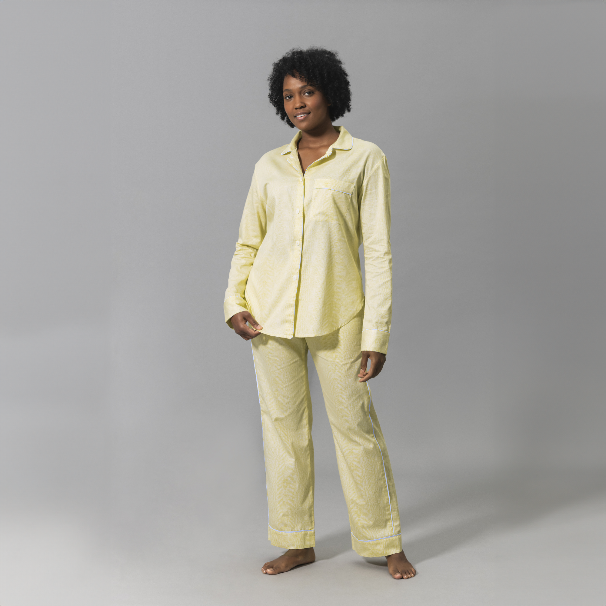 Woman Wearing a Matouk Jasper Pajama Set in Lemon and Blue Color