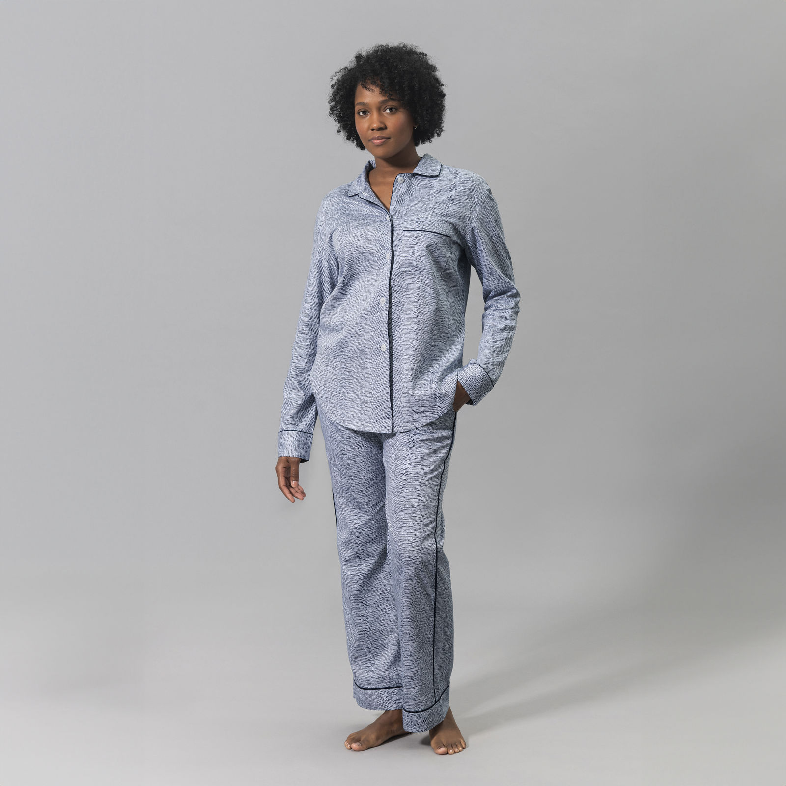 Woman Wearing a Matouk Jasper Pajama Set in Steel Blue and Navy Color