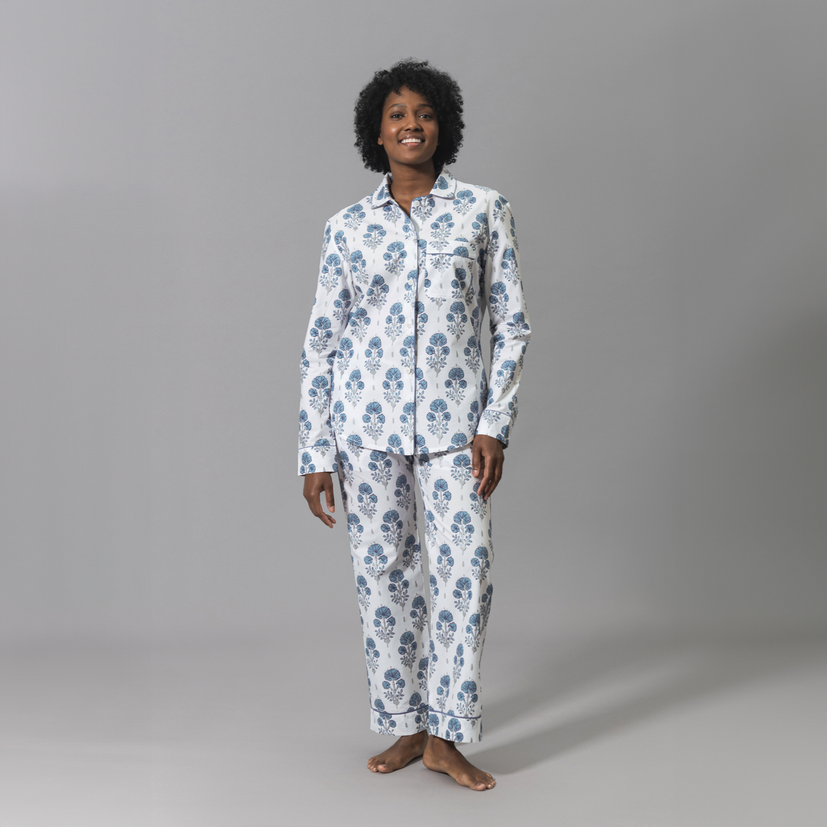 Woman Wearing a Lulu DK Matouk Joplin Pajama Set in Mineral Blue