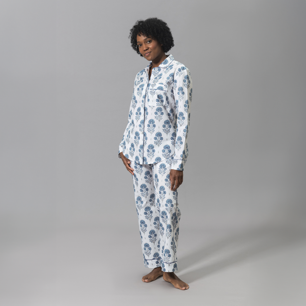 Side Angle of a Woman Wearing a Lulu DK Matouk Joplin Pajama Set in Mineral Blue