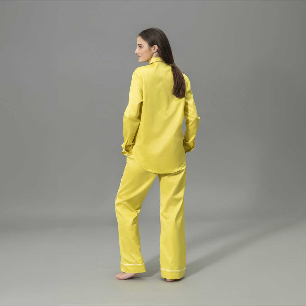 Behind View of Model Wearing Matouk Nocturne Pajama Set in Color Lemon and Bone