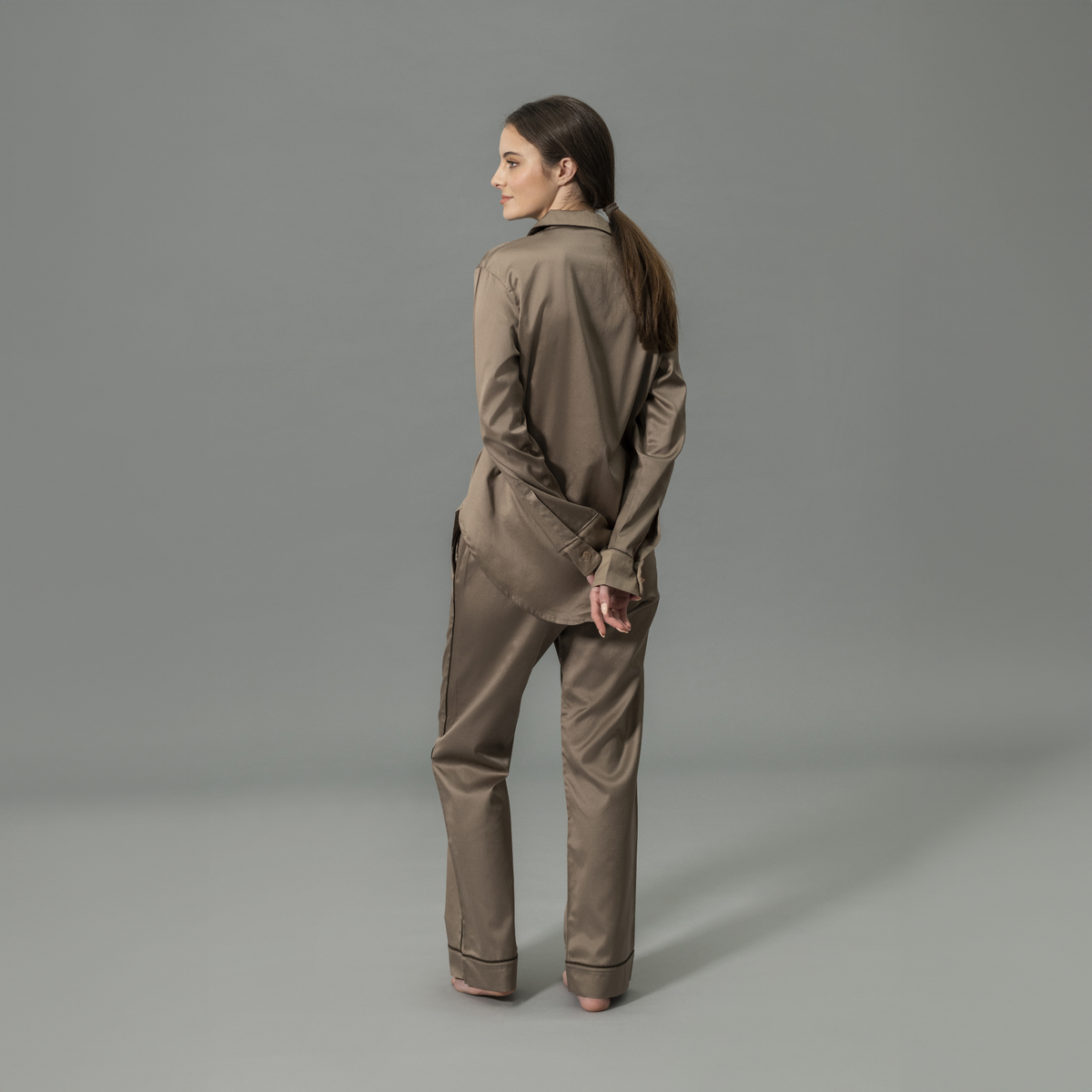 Behind View of Model Wearing Matouk Nocturne Pajama Set in Color Mocha and Sable