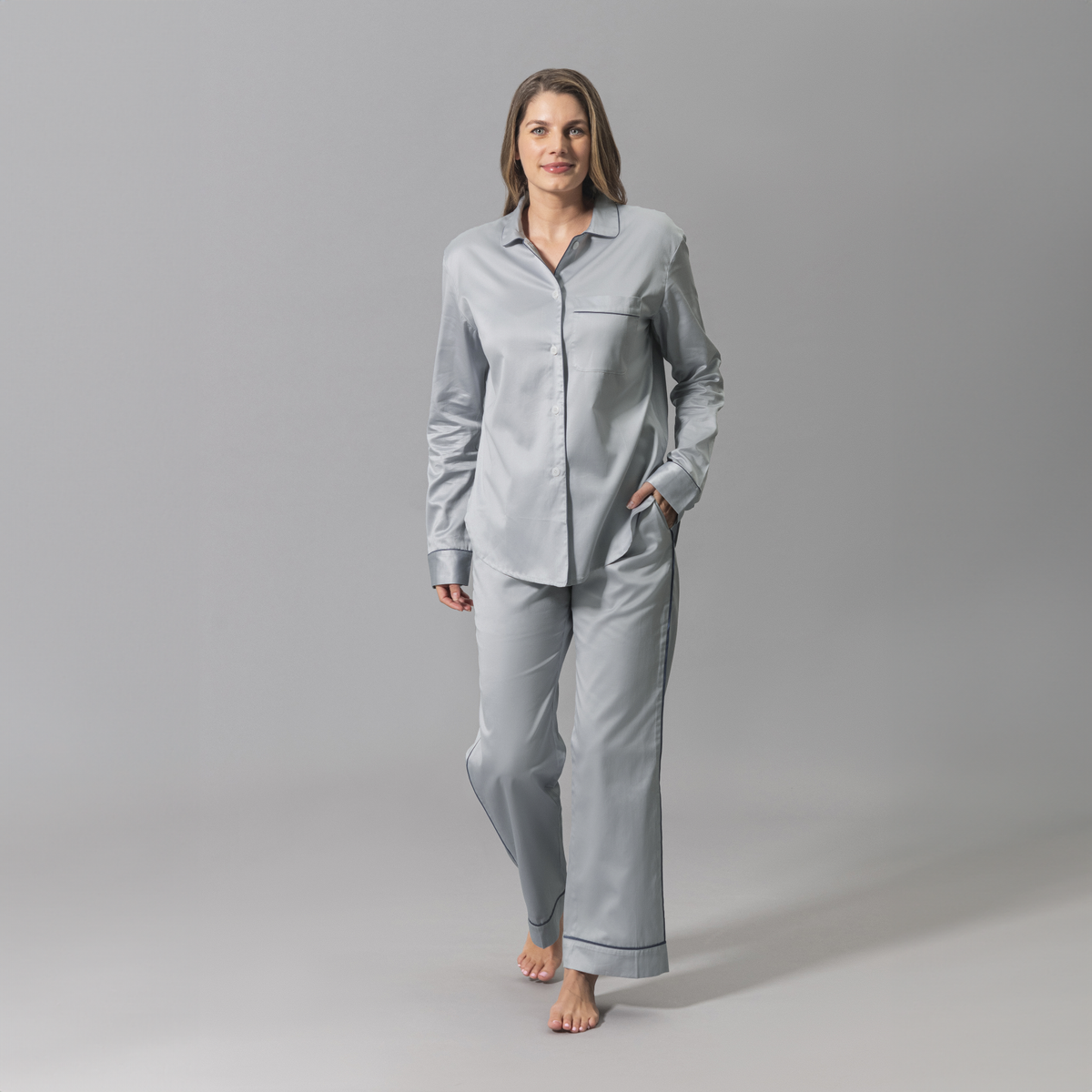 Woman Wearing a Matouk Nocturne Pajama Set in Dove Steel and Blue