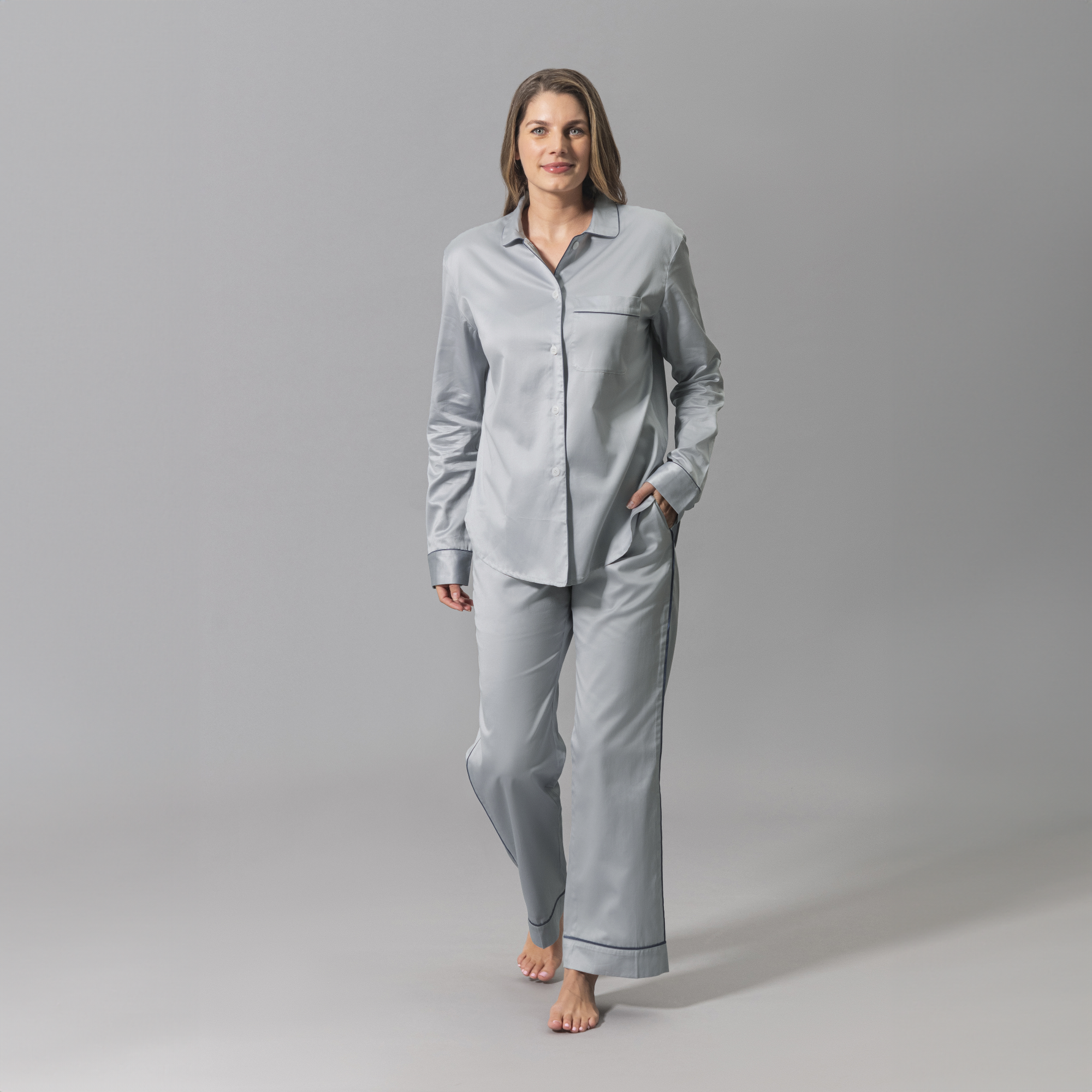 Woman Wearing a Matouk Nocturne Pajama Set in Dove Steel and Blue