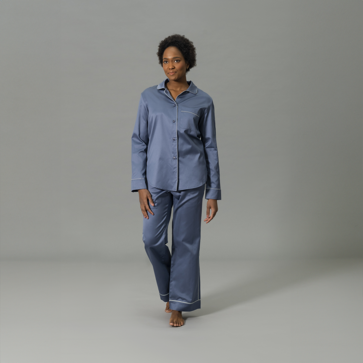 Front View of Model Wearing Matouk Nocturne Pajama Set in Color Steel Blue and Dove