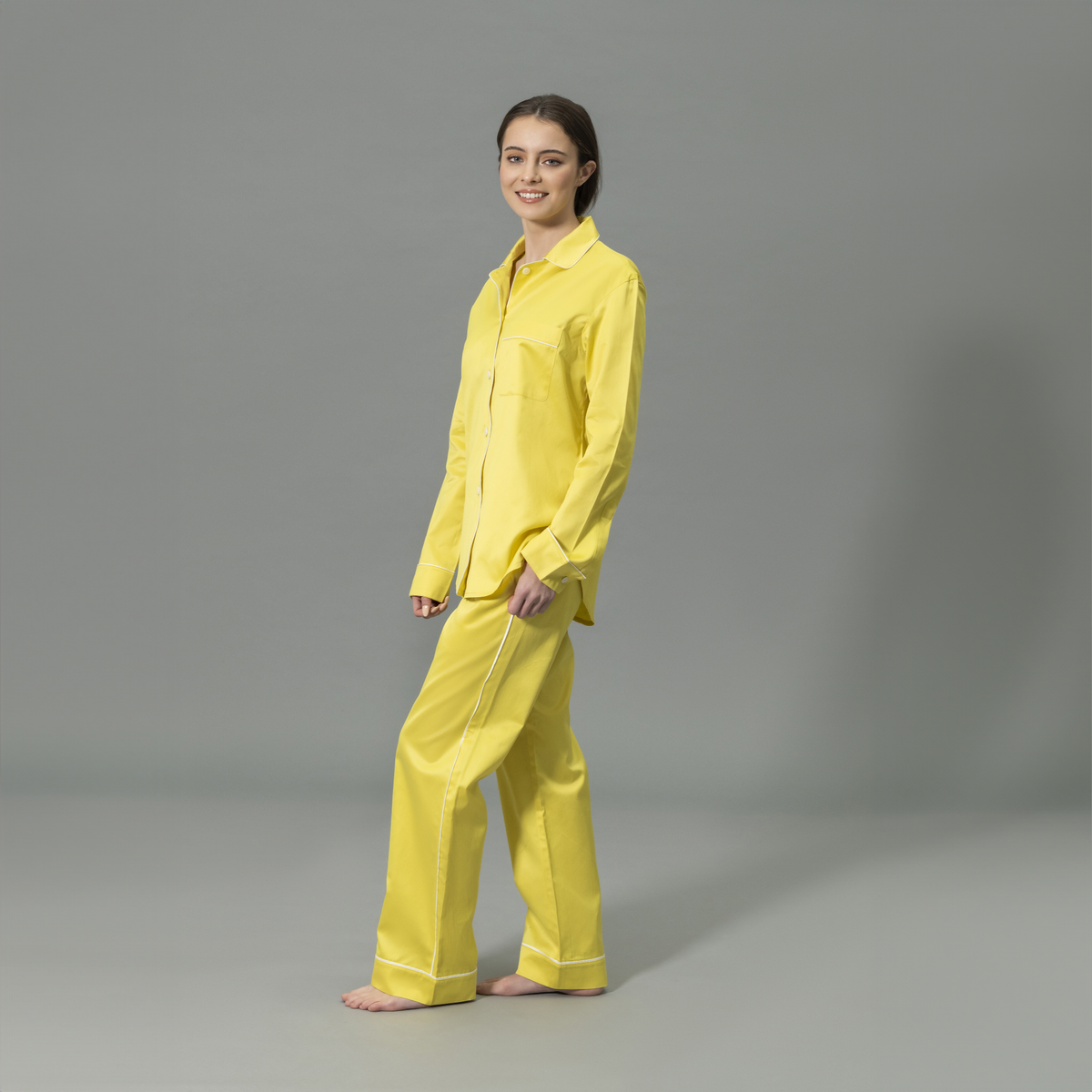 Side View of Model Wearing Matouk Nocturne Pajama Set in Color Lemon and Bone