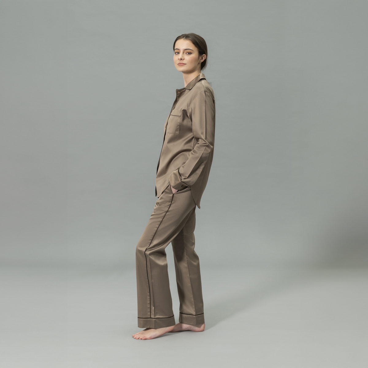 Side View of Model Wearing Matouk Nocturne Pajama Set in Color Mocha and Sable