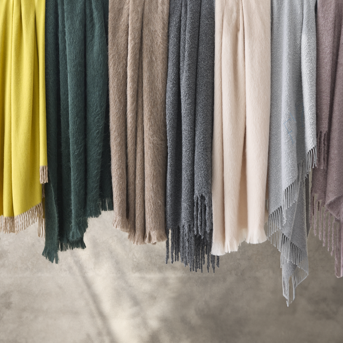 Hanging Matouk Paley Bruno Poncho Helix Throws in Different Colors