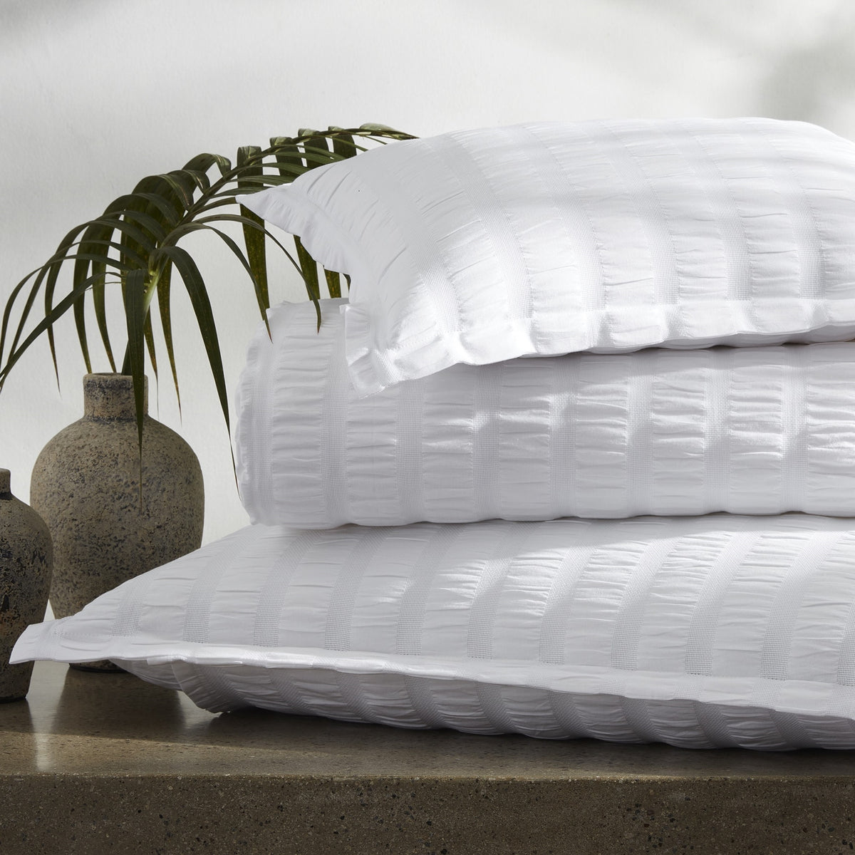 Lifestyle Shot of Stacks of Matouk Panama Bedding in White Color
