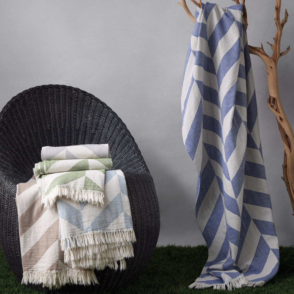 Lifestyle Shot of Matouk Paros Beach Towels in Different Colors