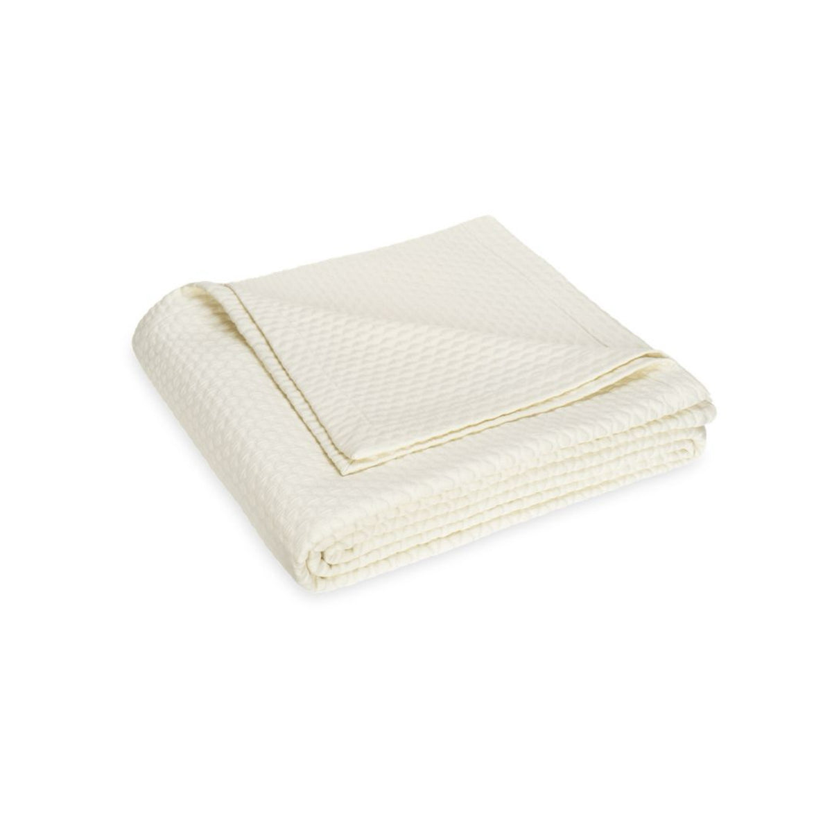 A neatly folded cream-colored Matouk Perla Bedding blanket, crafted from 100% cotton, on a white background.