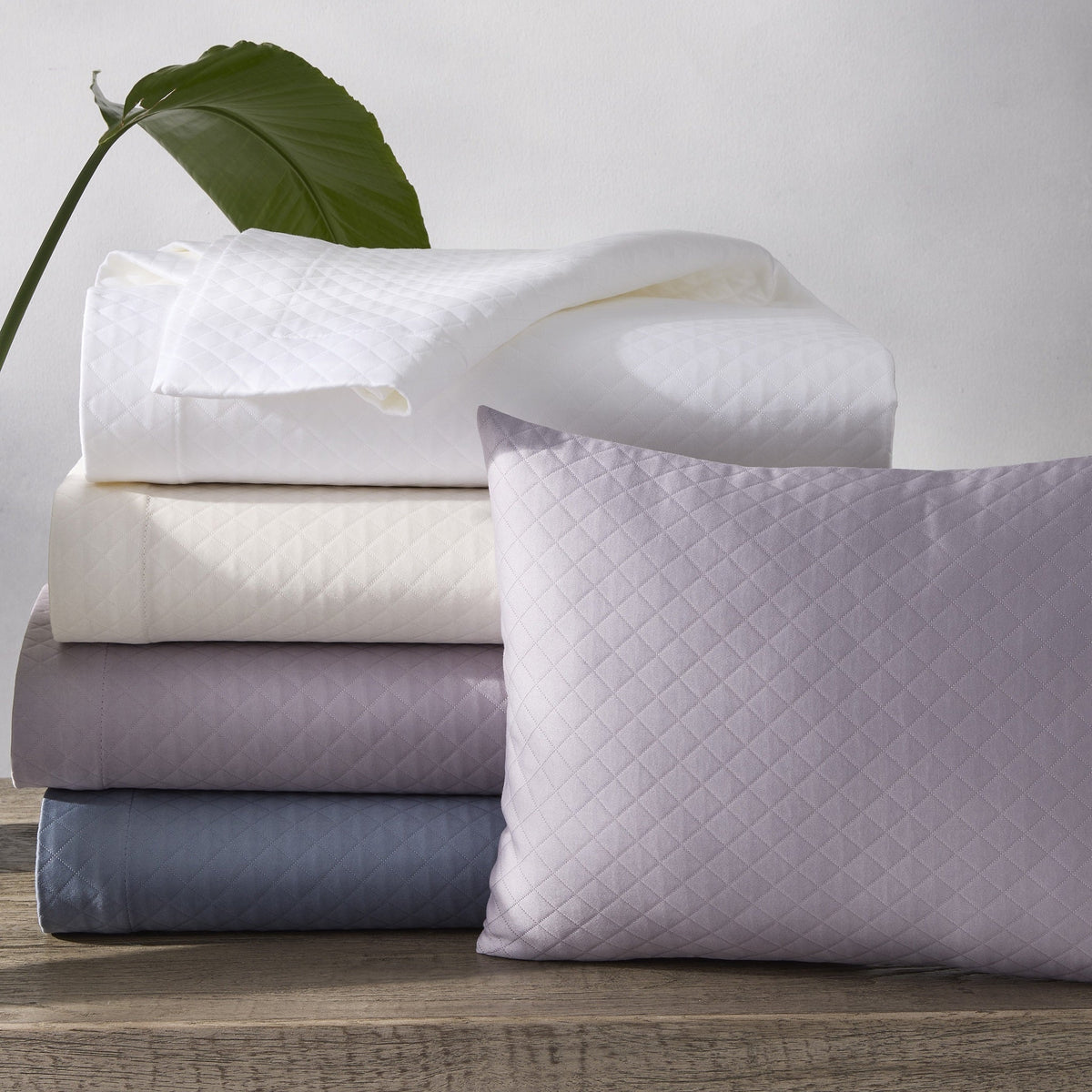 Stack of Matouk Petra Bedding in Different Colors
