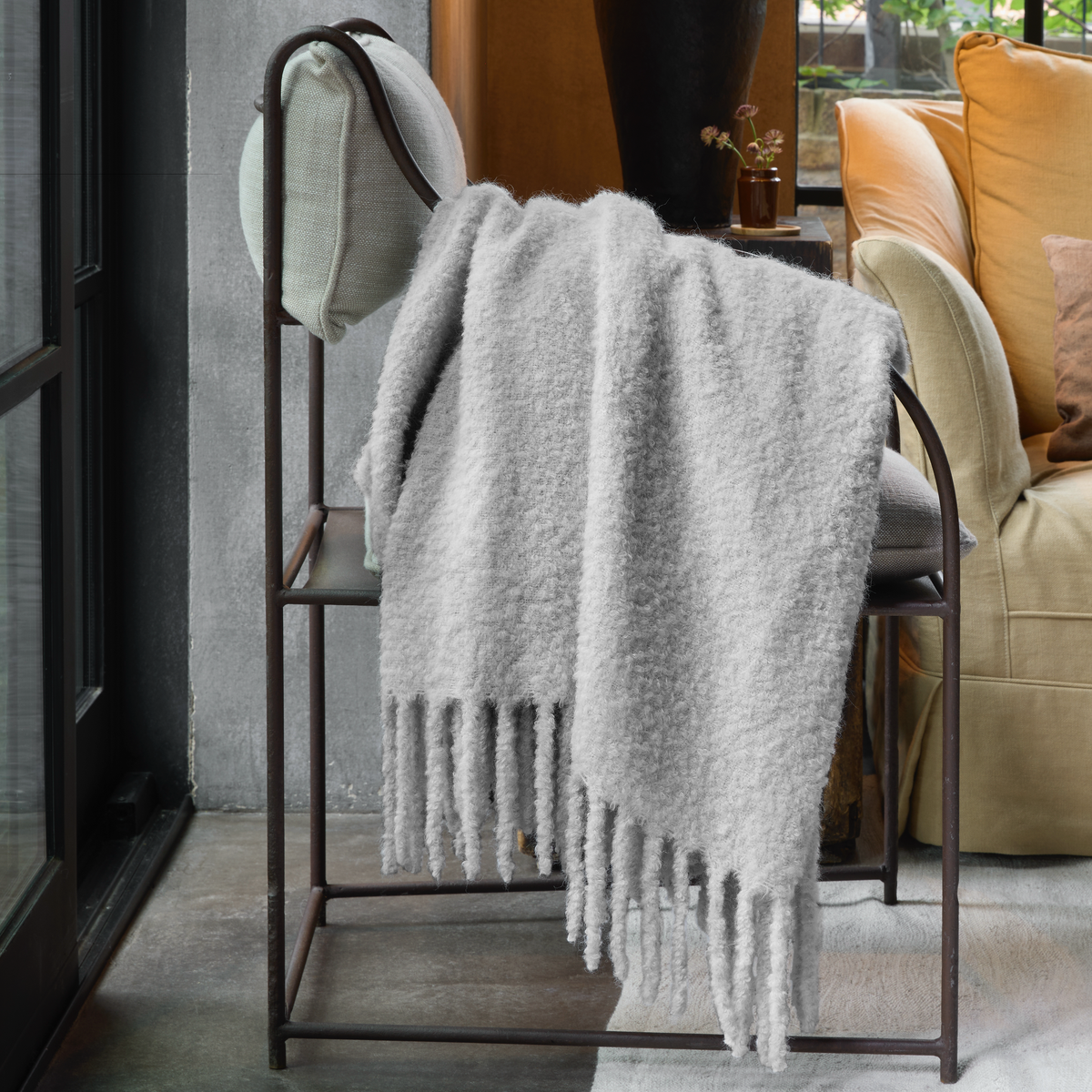 Silver Matouk Poncho Throw on a couch