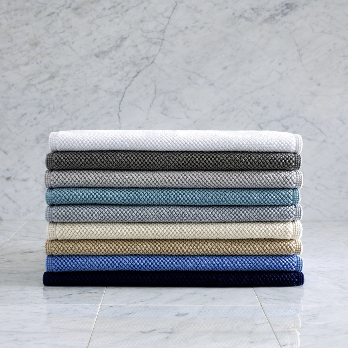 Stack of Matouk Reverie Bath Rugs