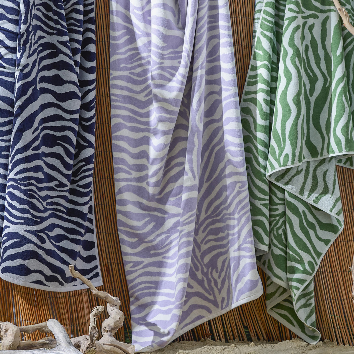 Lifestyle Shot of Matouk Santiago Beach Towels in All Colors