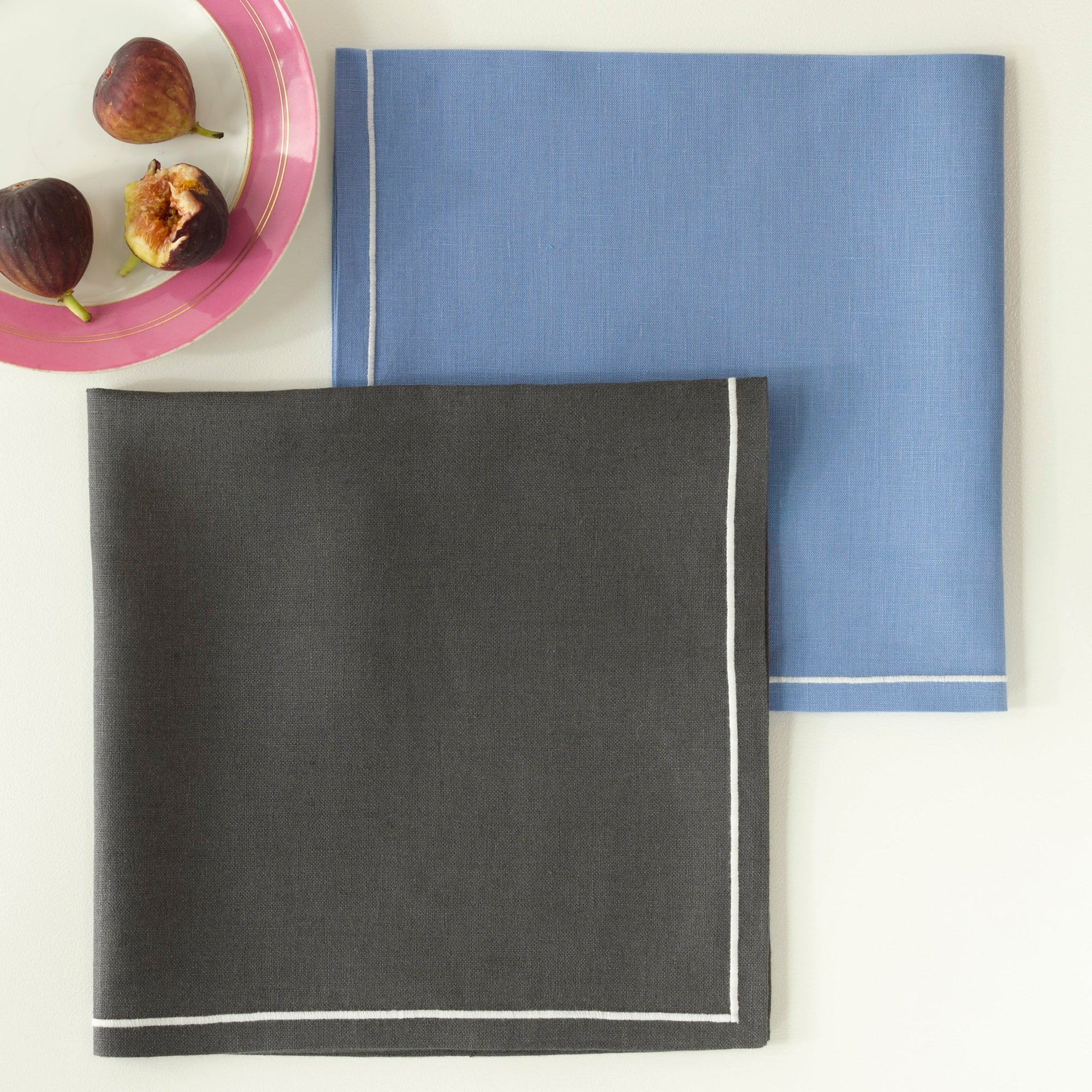 Folded Matouk Satin Stitch Napkins in Color Smoke Grey and Sky Blue