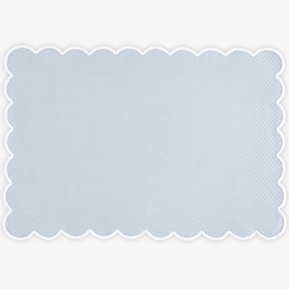 Light blue Matouk Savannah Gardens placemat on white background