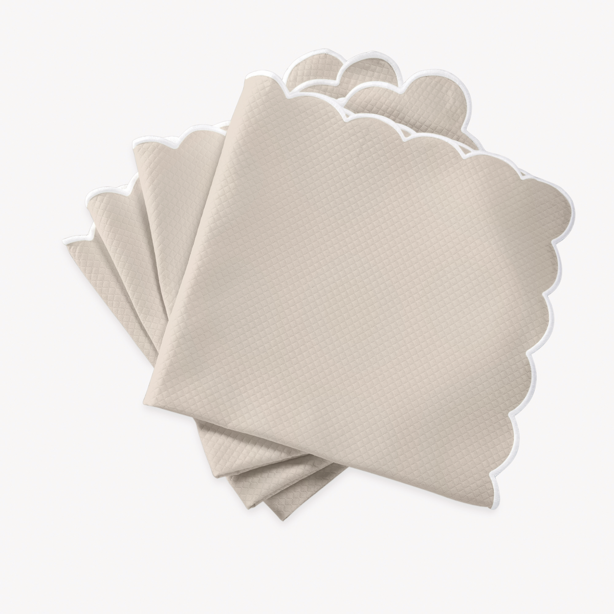 Dune napkins with scalloped edges of Matouk Savannah Gardens table linens