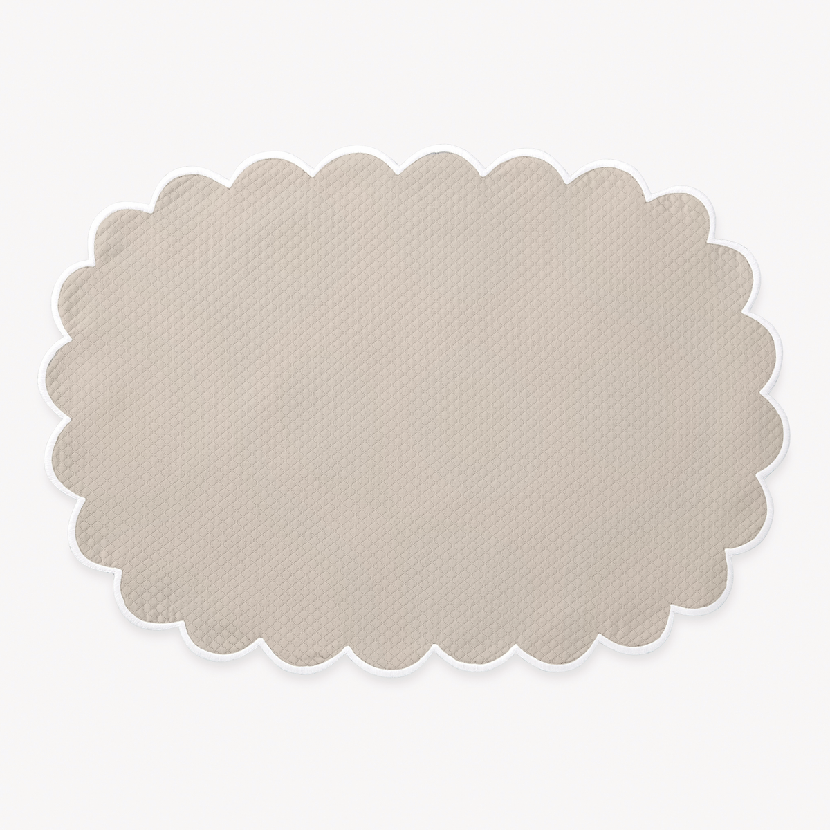Dune oval placemat with a scalloped edge from Matouk Savannah Gardens table linens