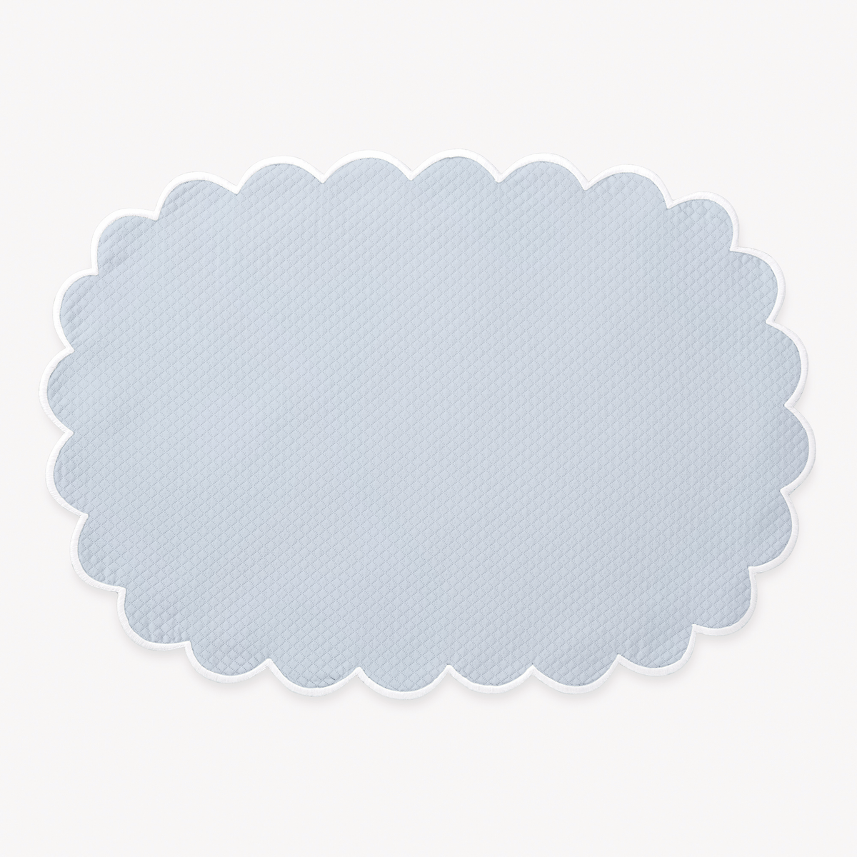Light Blue oval placemat with a scalloped edge from Matouk Savannah Gardens table linens