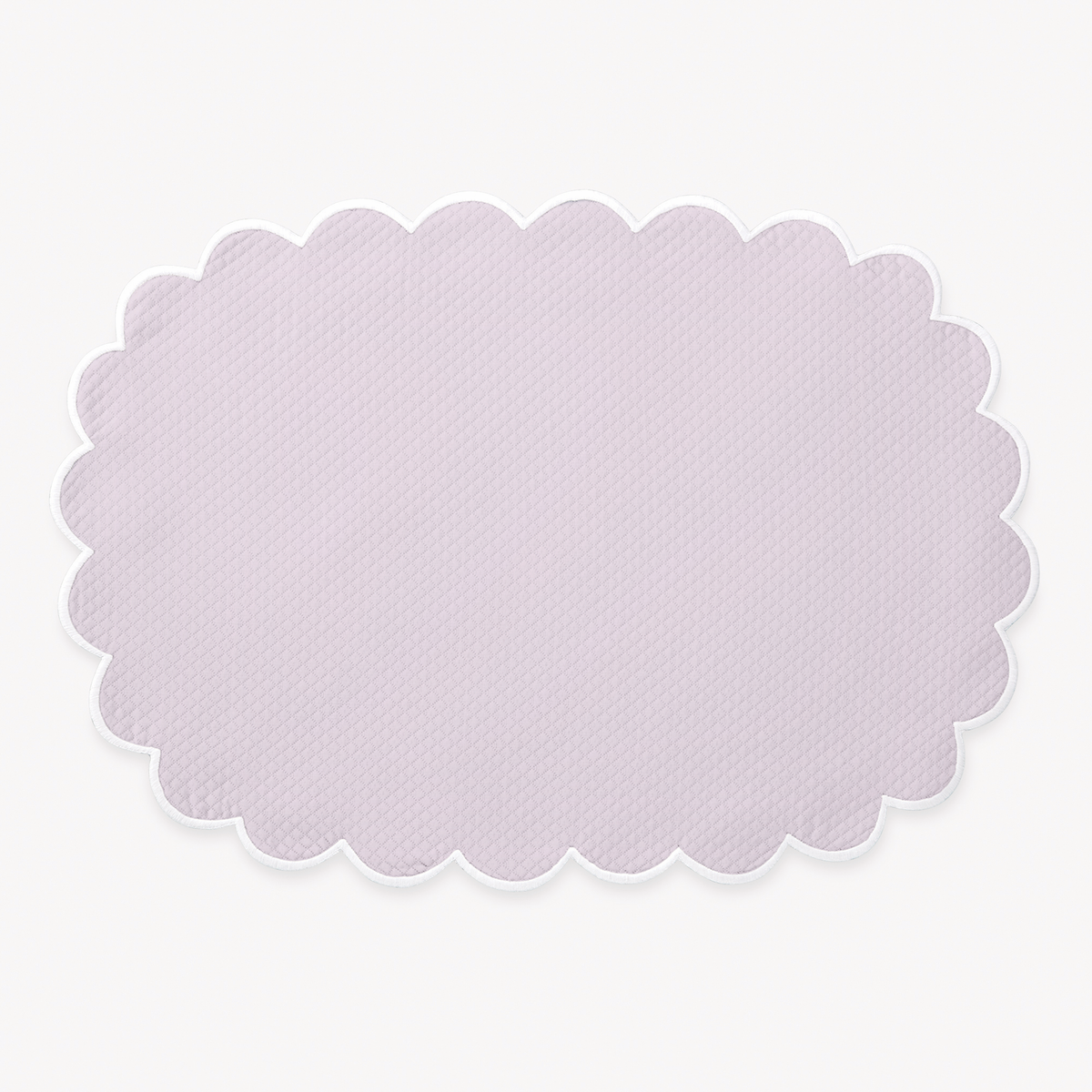 Violet oval placemat with a scalloped edge from Matouk Savannah Gardens table linens