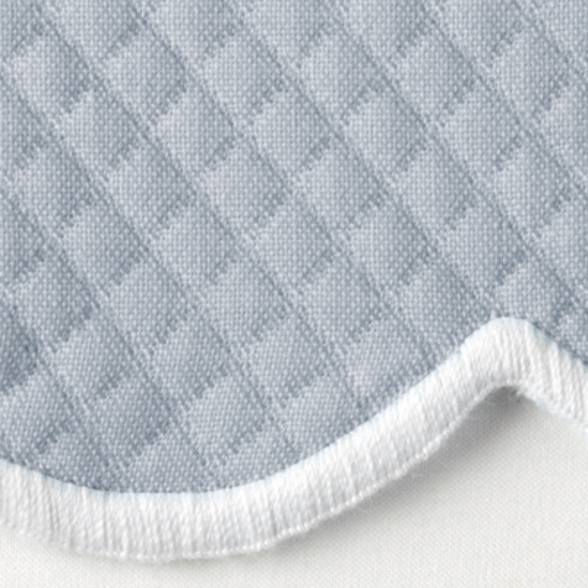 Close-up of HazyBlue Matouk Savannah Gardens diamond pique table linens