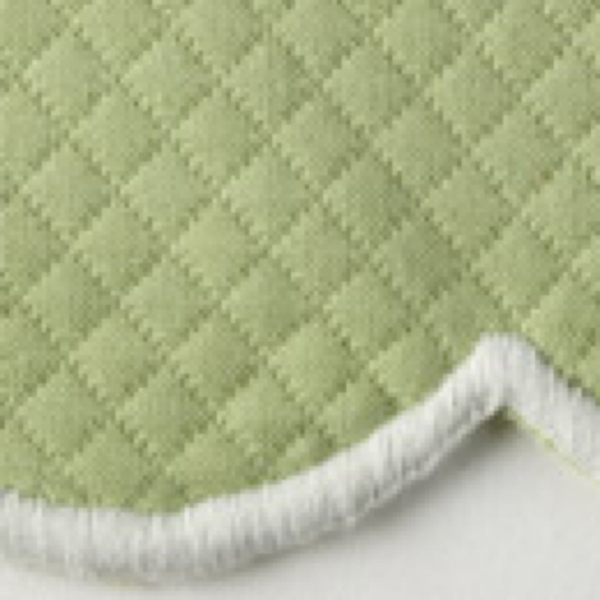 Close-up of SpringGreen Matouk Savannah Gardens diamond pique table linens