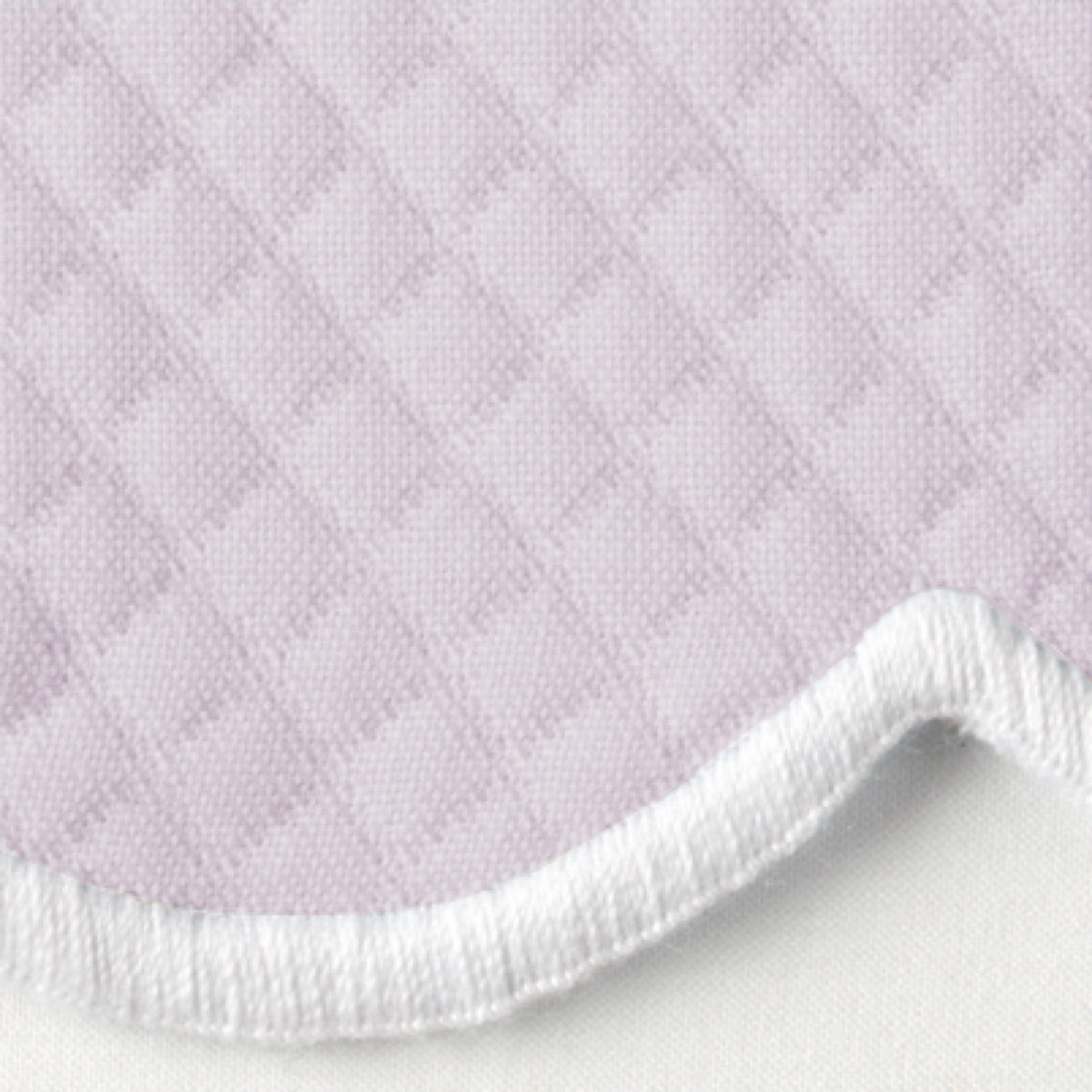 Close-up of Violet Matouk Savannah Gardens diamond pique table linens