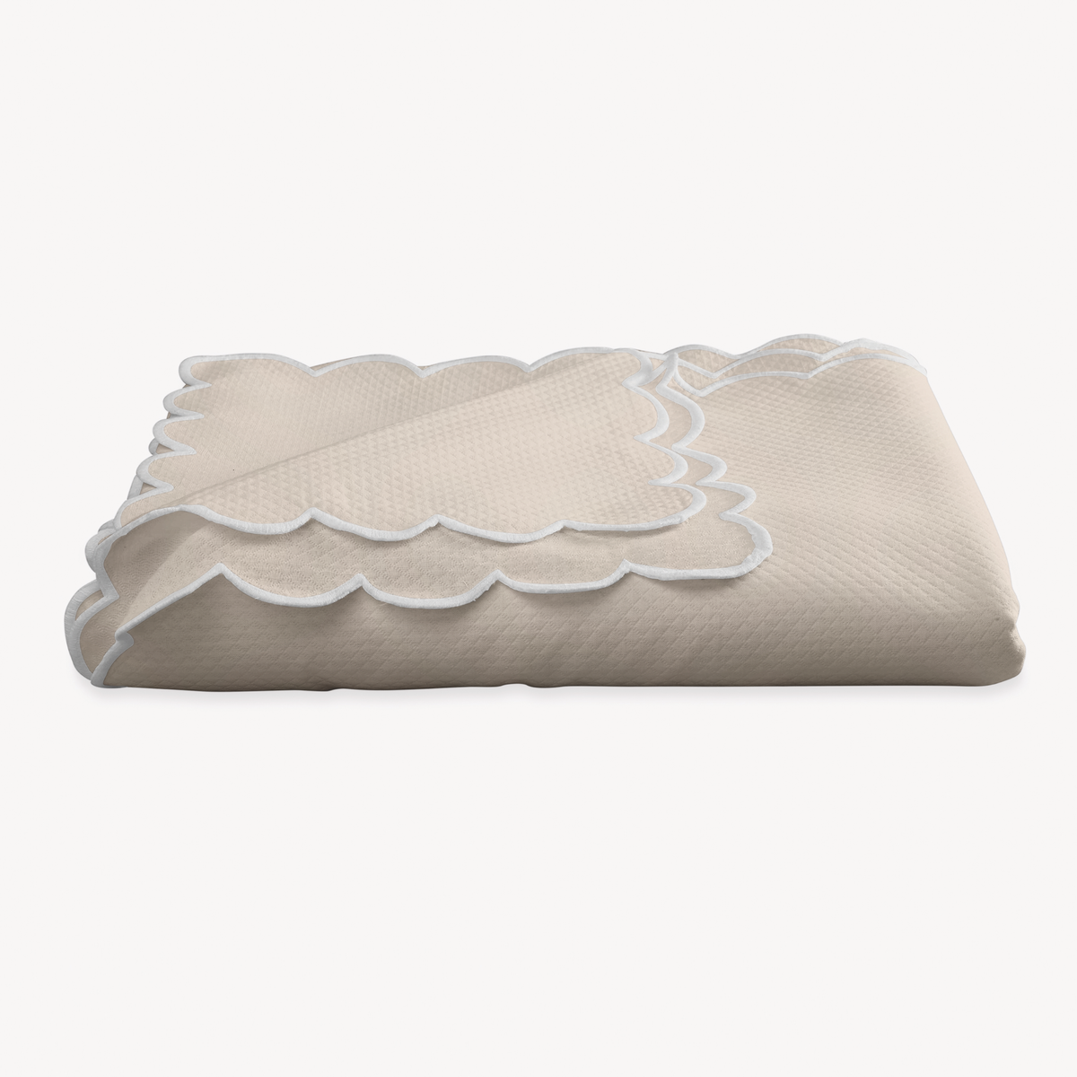 A folded Dune Matouk Savannah Gardens Tablecloth on a white background