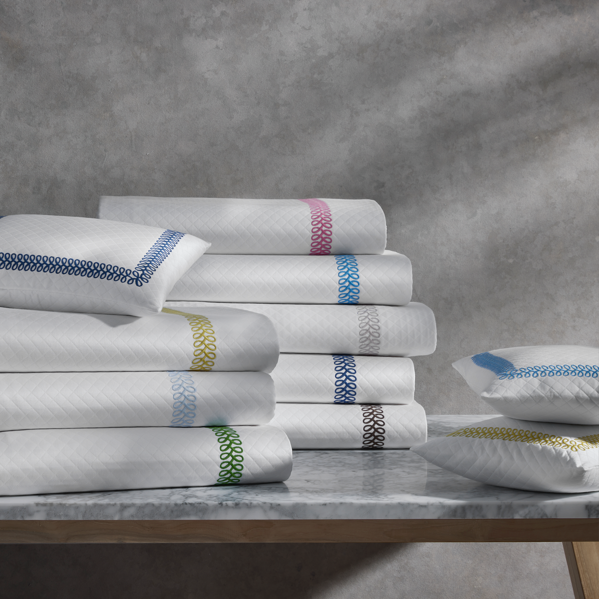 Folded Stacks of Matouk Schumacher Astor Braid Matelassé Bedding