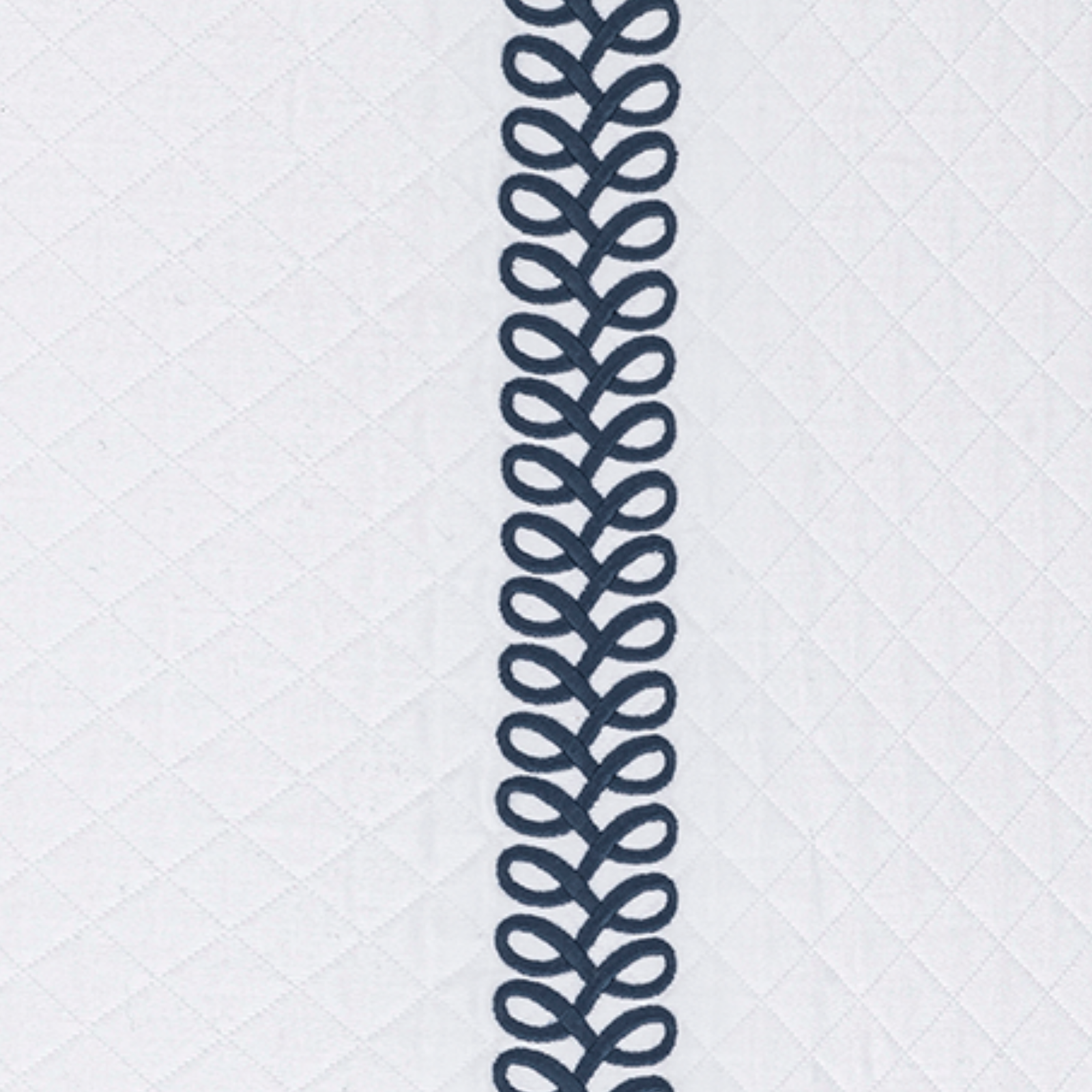 Full Bed Dressed in Matouk Schumacher Astor Braid Matelassé Bedding with Indigo Swatch