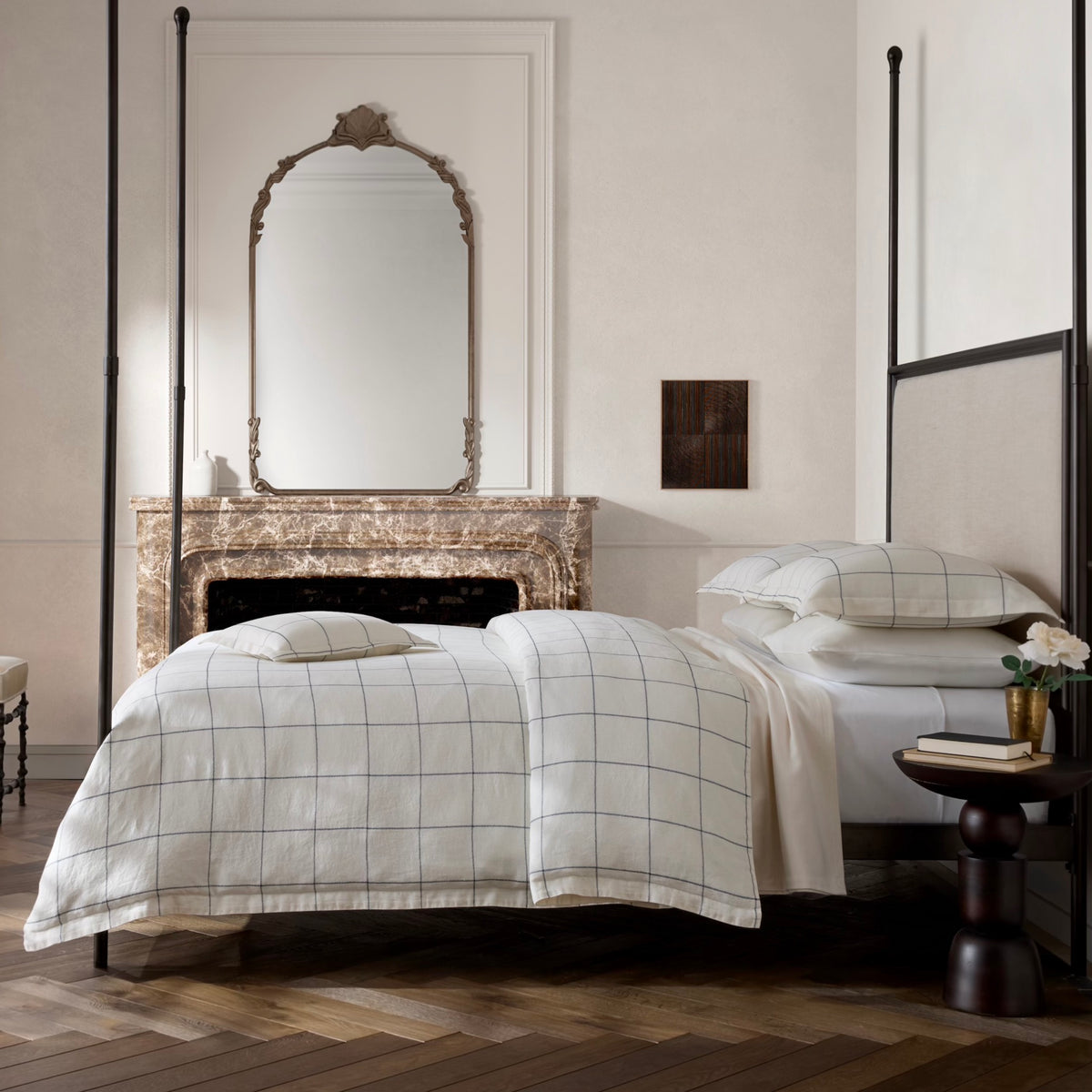 Side view of a bed with Matouk Schumacher Sebastian Bedding in Navy color