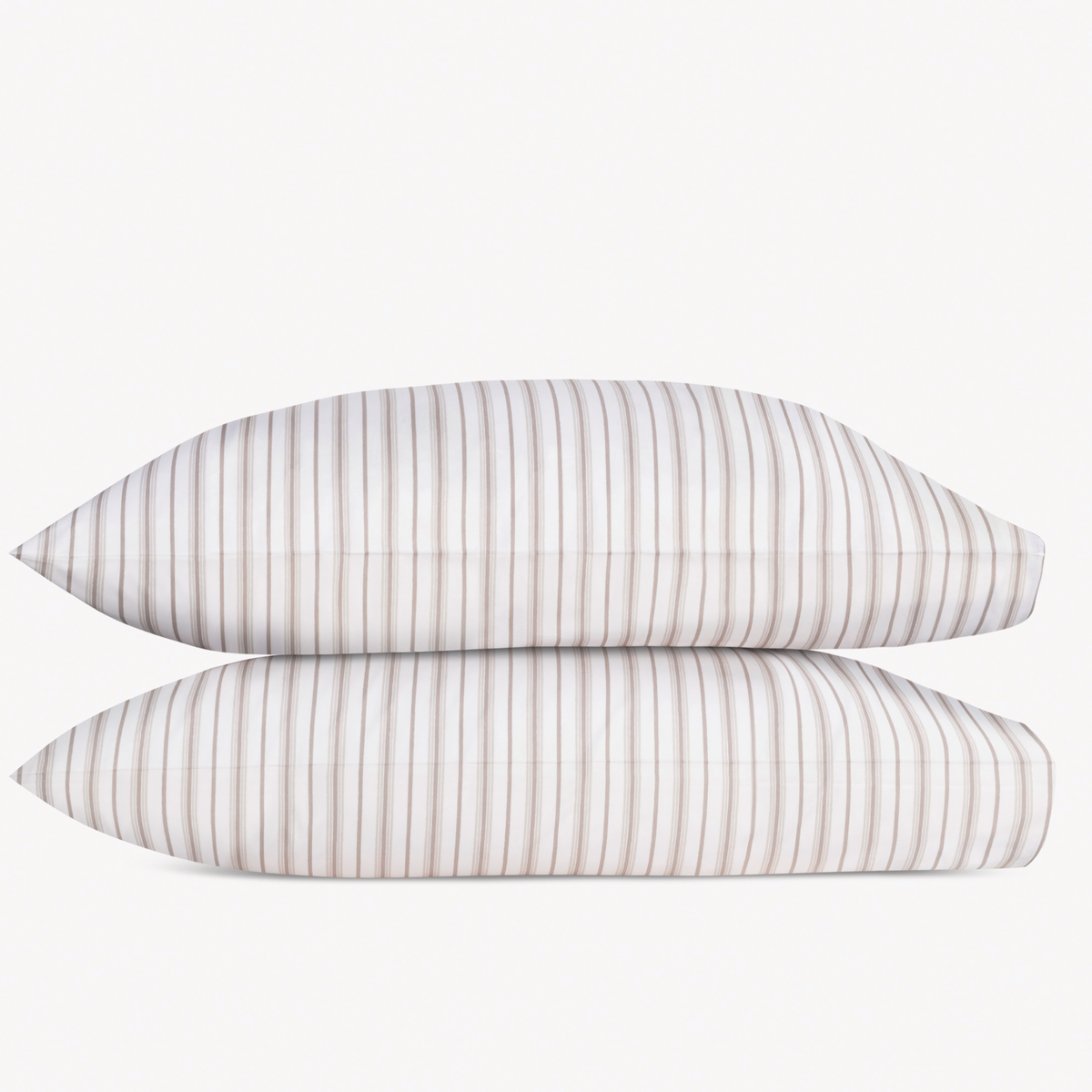 Two Pebble Matouk Calypso Pillowcases stacked against a plain background