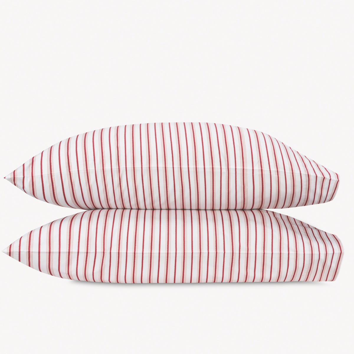 Two Red Berry Matouk Calypso Pillowcases stacked against a plain background