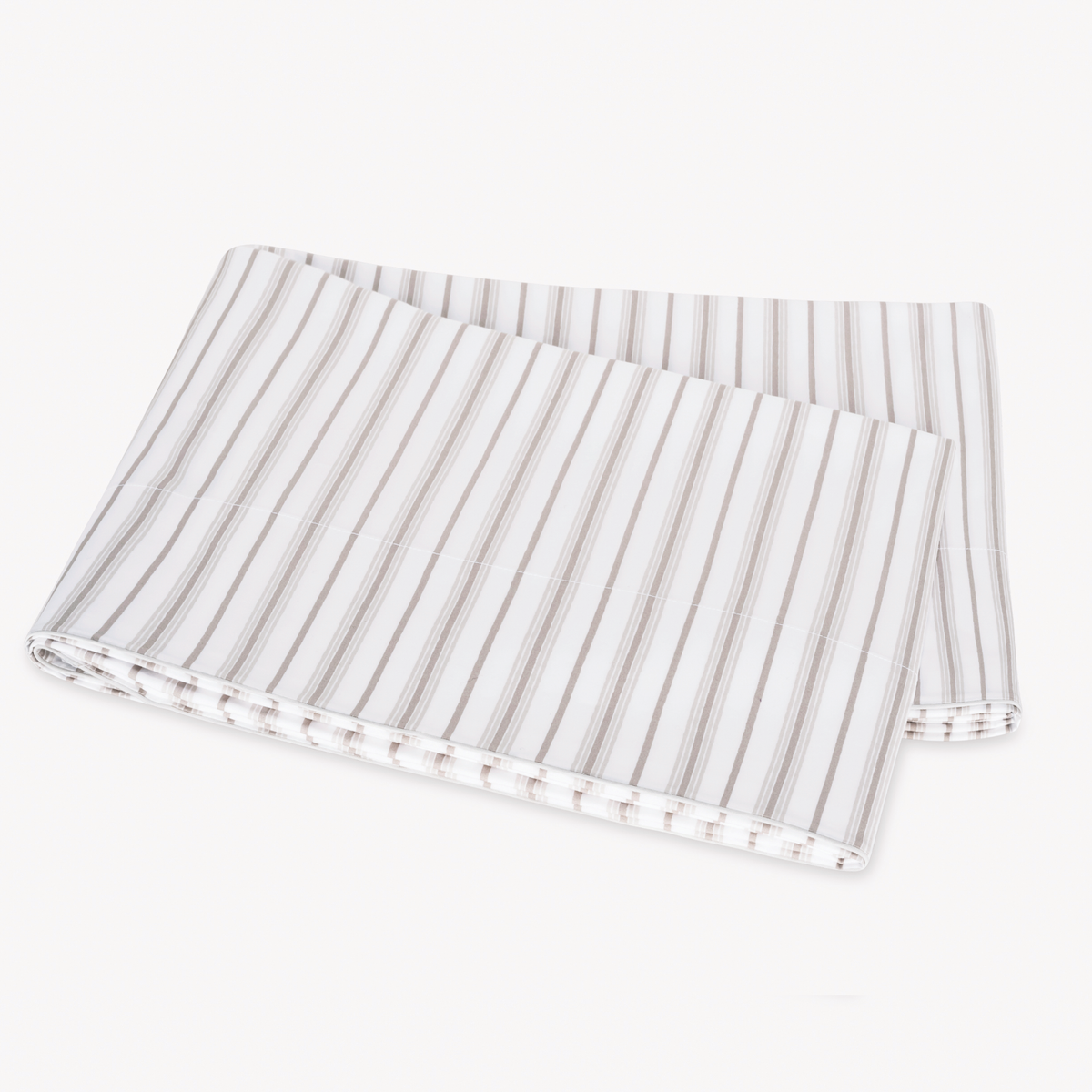 Folded Pebble Matouk Calypso Flat Sheet on a plain white surface
