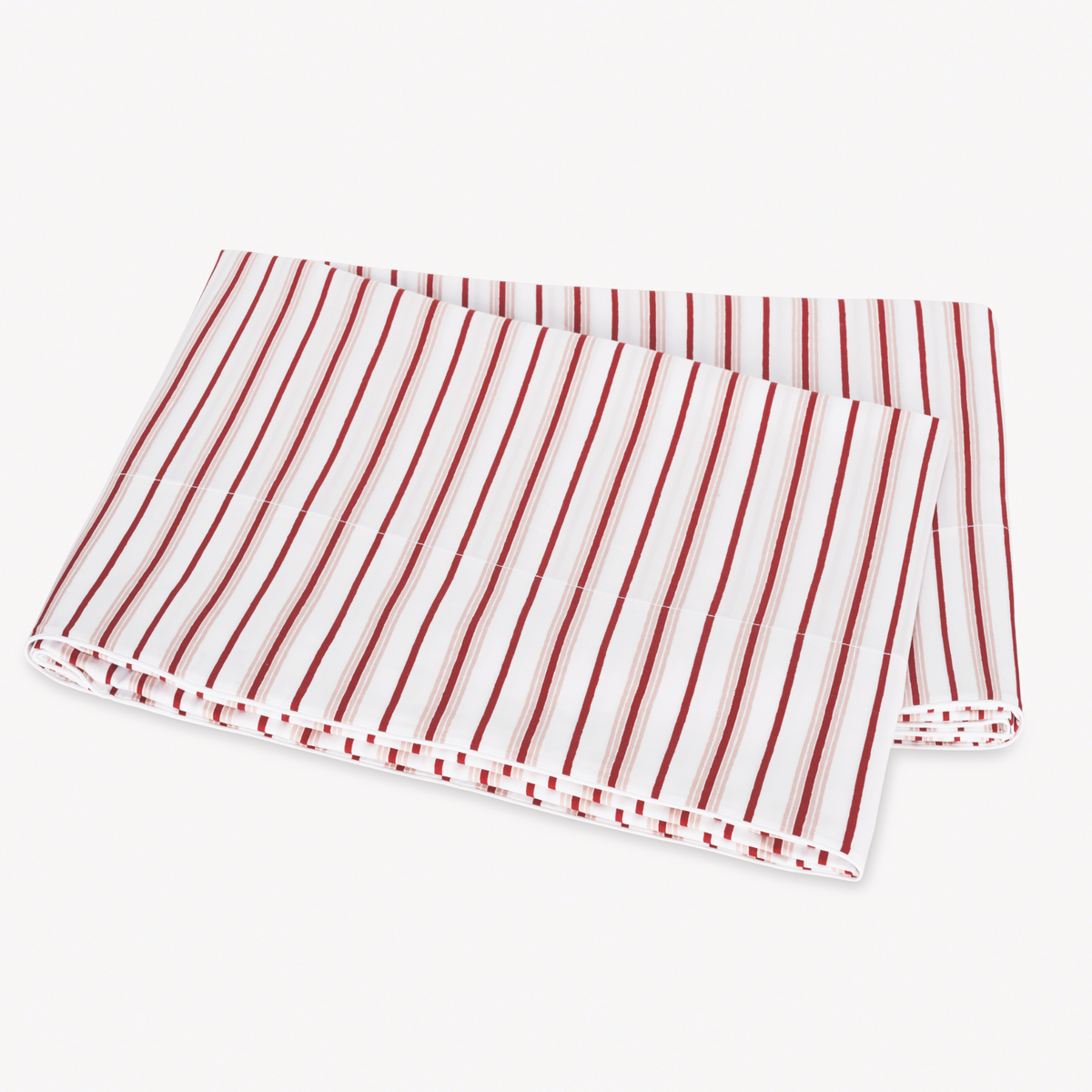 Folded Red Berry Matouk Calypso Flat Sheet on a plain white surface