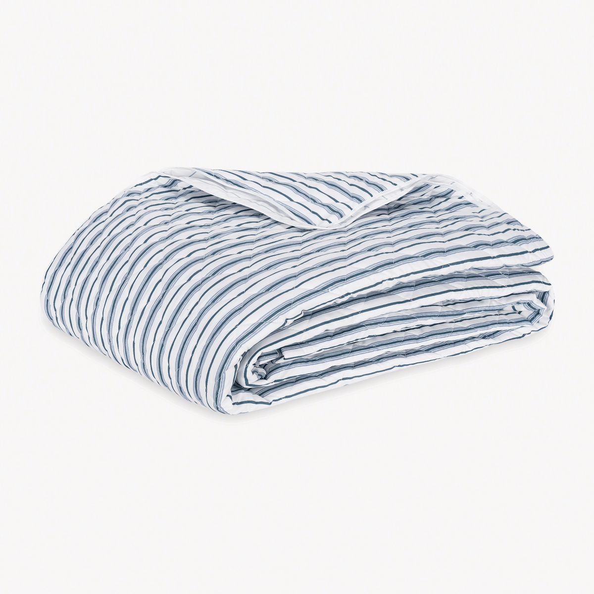 Folded Quilt Coverlet of Matouk Calypso Bedding style in Prussian Blue Color