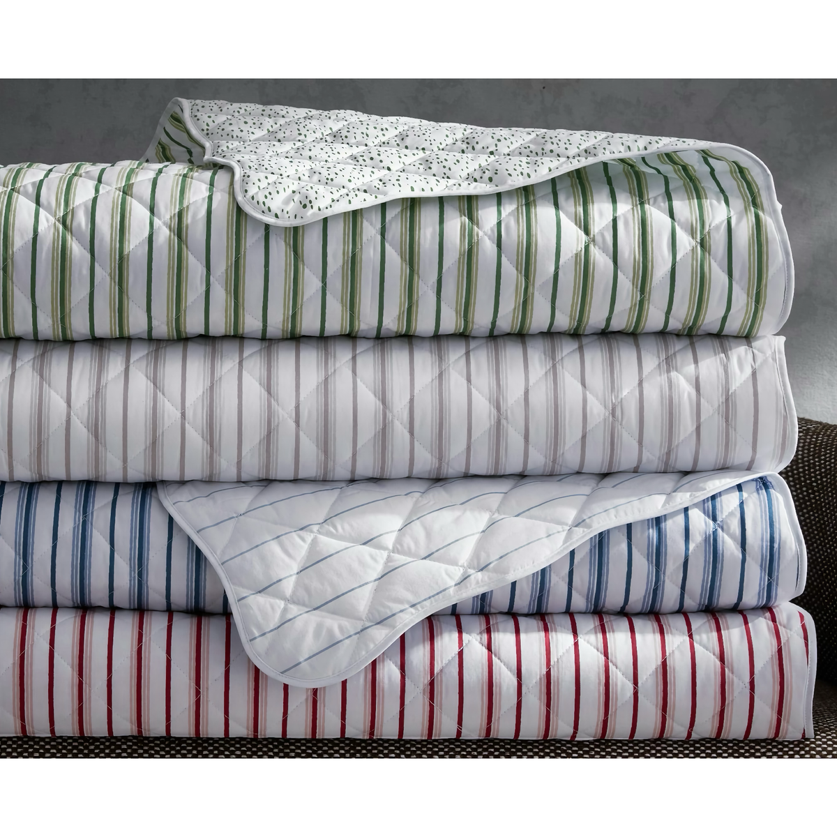 Four folded Matouk Calypso Bedding quilts in 2026 colors